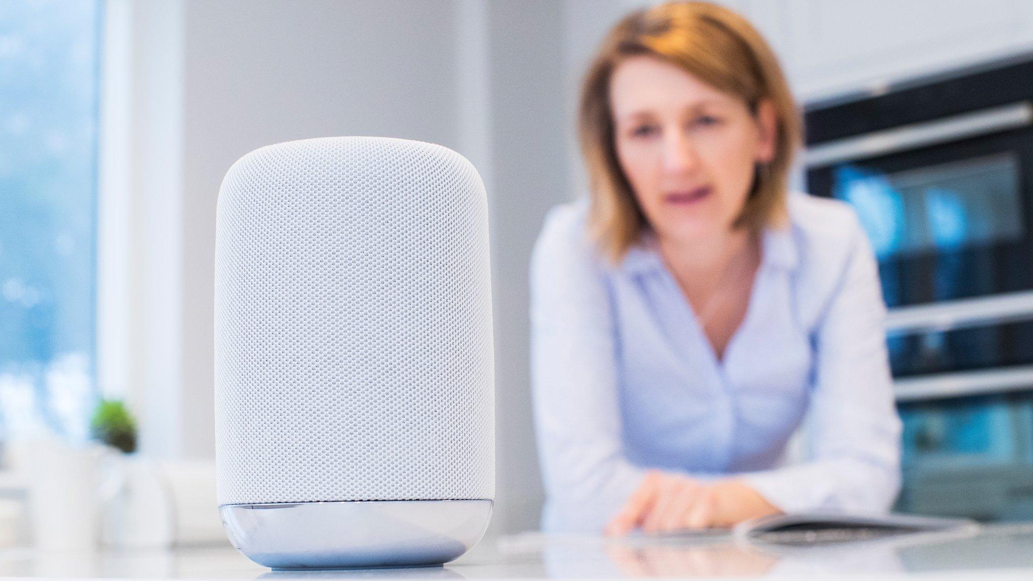 A woman uses her voice command device