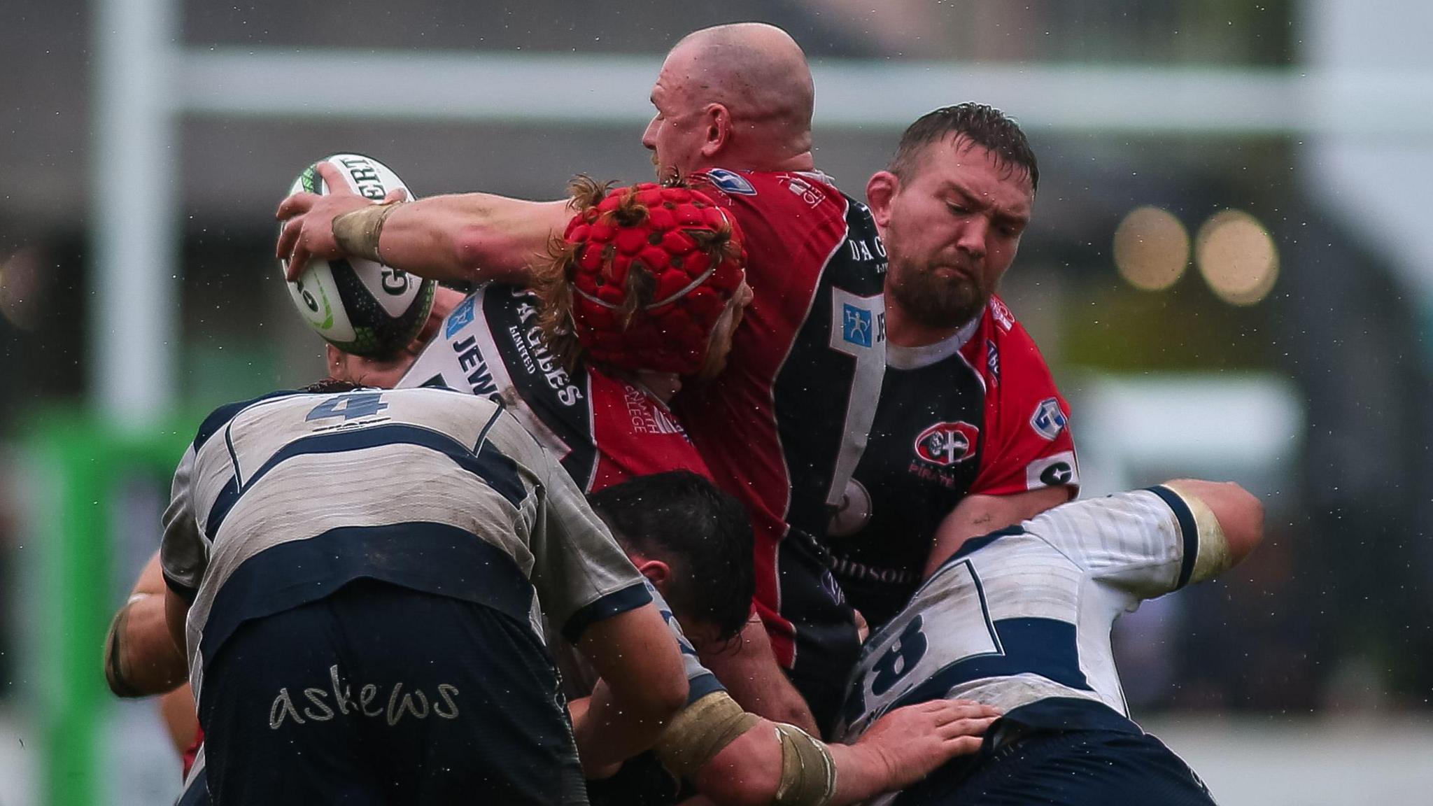 Cornish Pirates players recycle the ball during a match