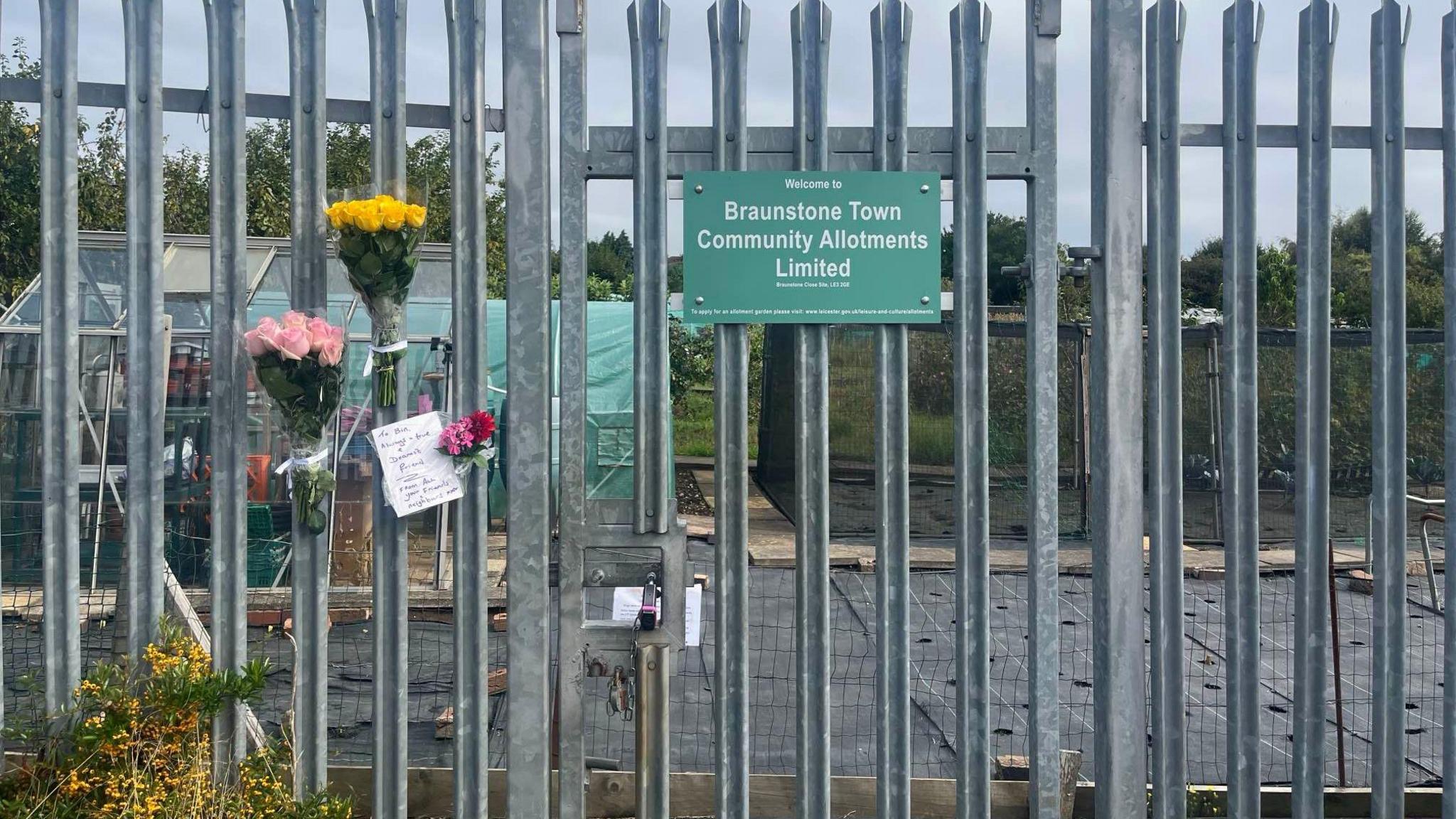 Floral tributes placed on fencing at allotment