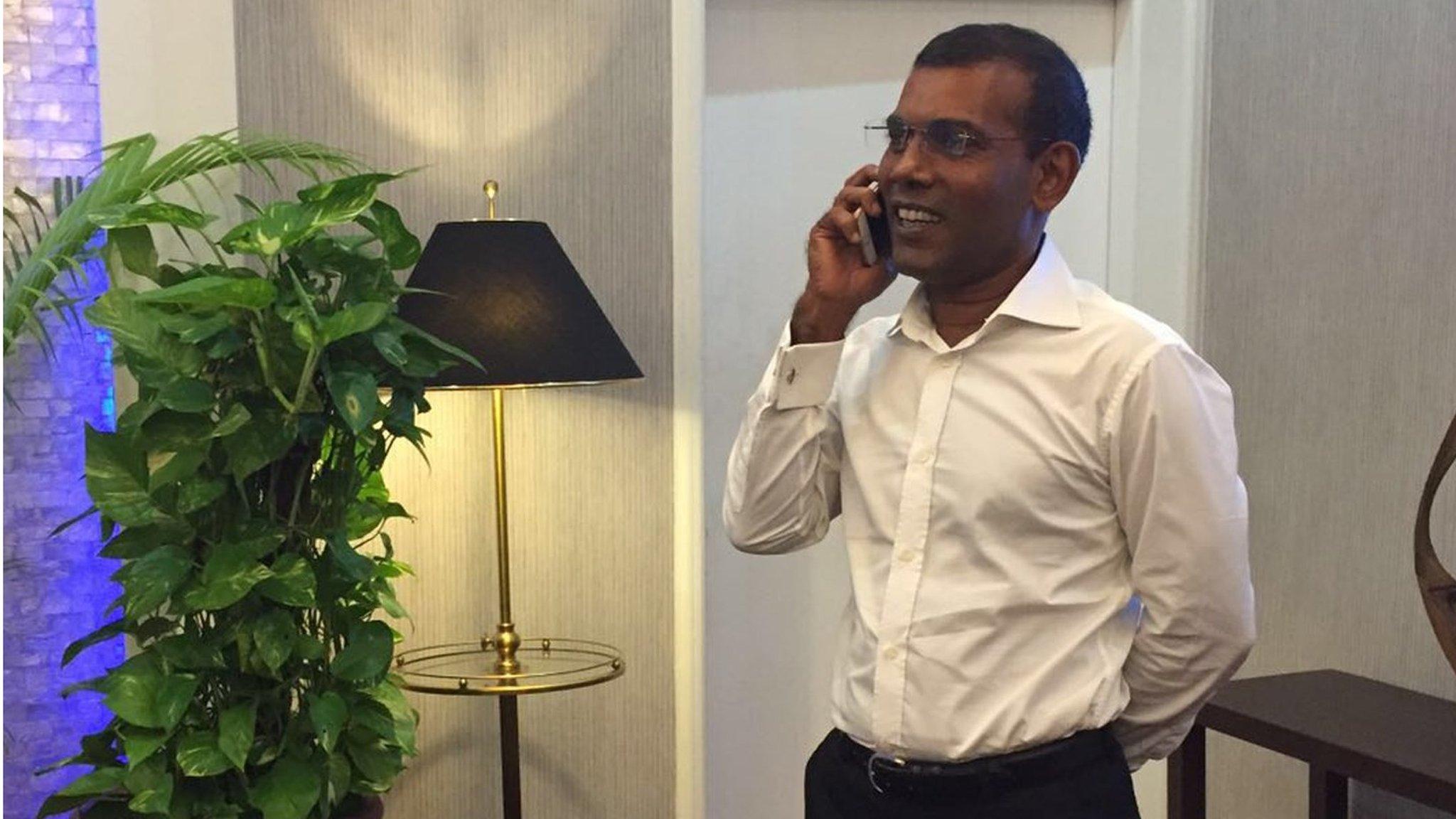 opposition leader Mohamed Nasheed talks on the phone as he prepares to leave the Maldives (MDP handout) (18 January 2016)