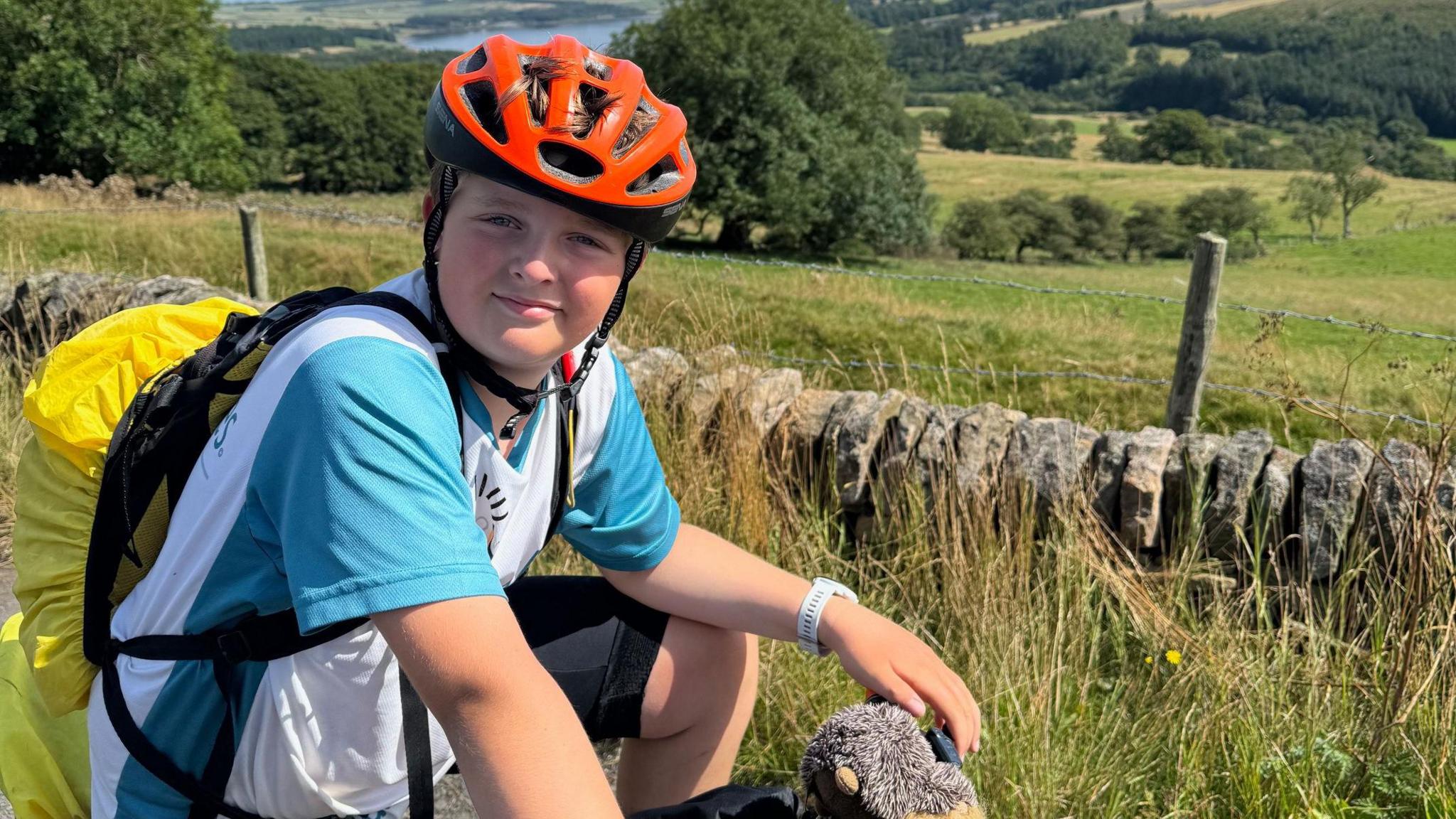 Harry with his helmet and rucksack on his bike 