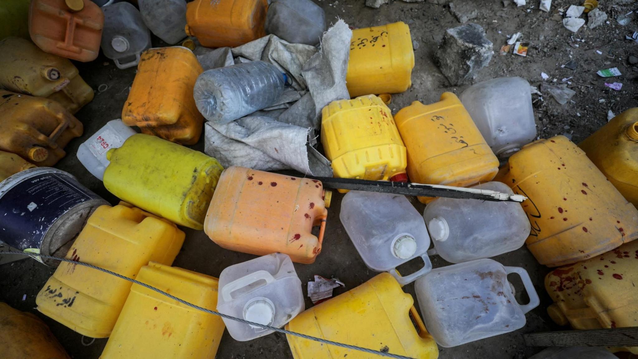 Abandoned jerrycans at the site of an Israeli strike that killed 10 Palestinians, including six children, who were queueing at a water distribution point, in Nuseirat refugee camp, central Gaza (13 July 2025)
