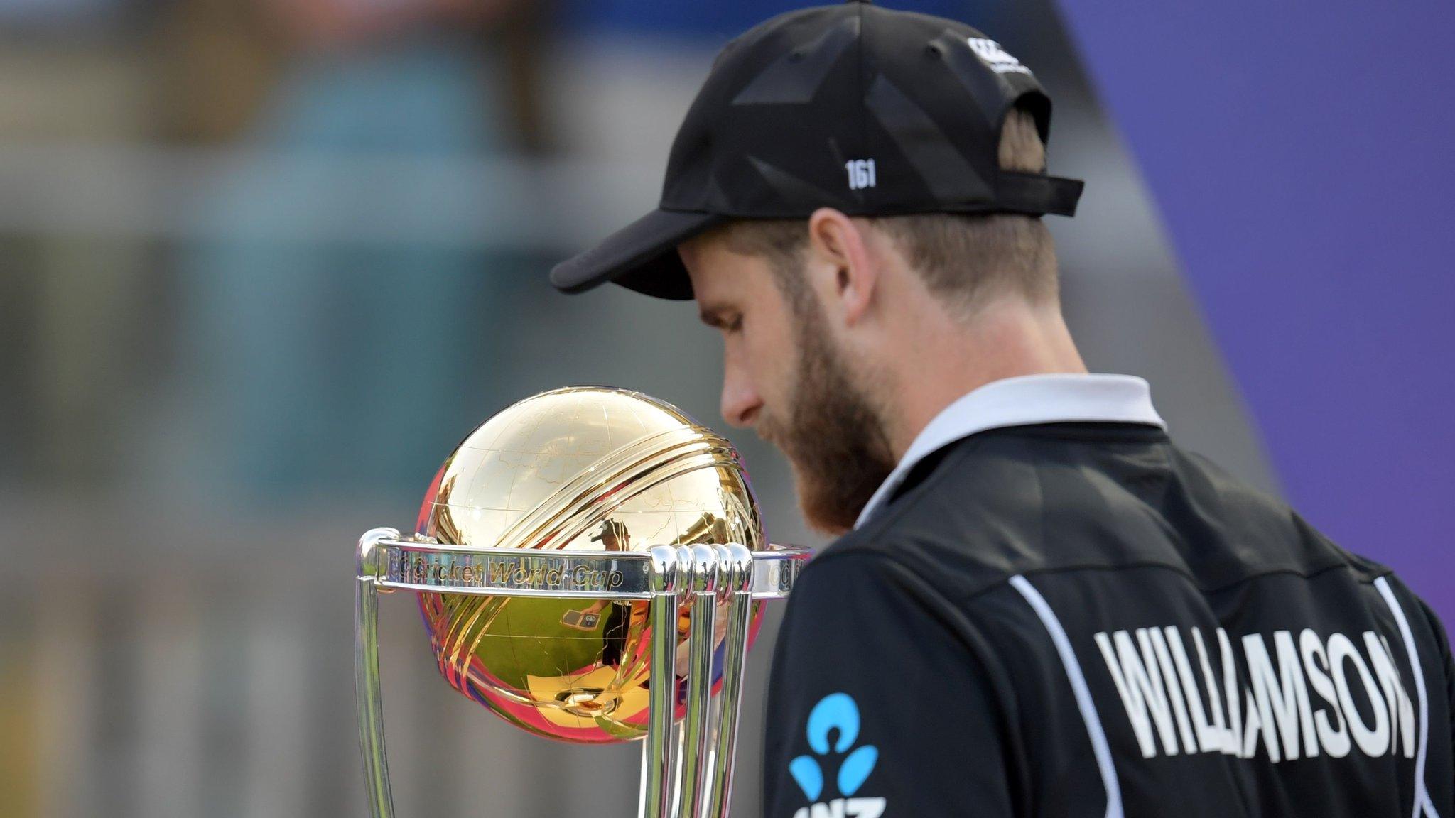 Kane Williamson walks past World Cup trophy