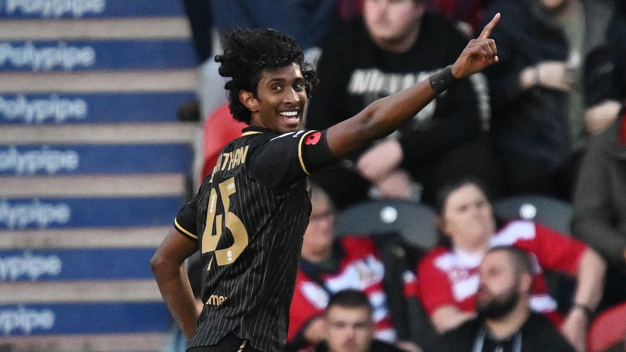 Vimal Yoganathan points to the crowd after scoring for Barnsley