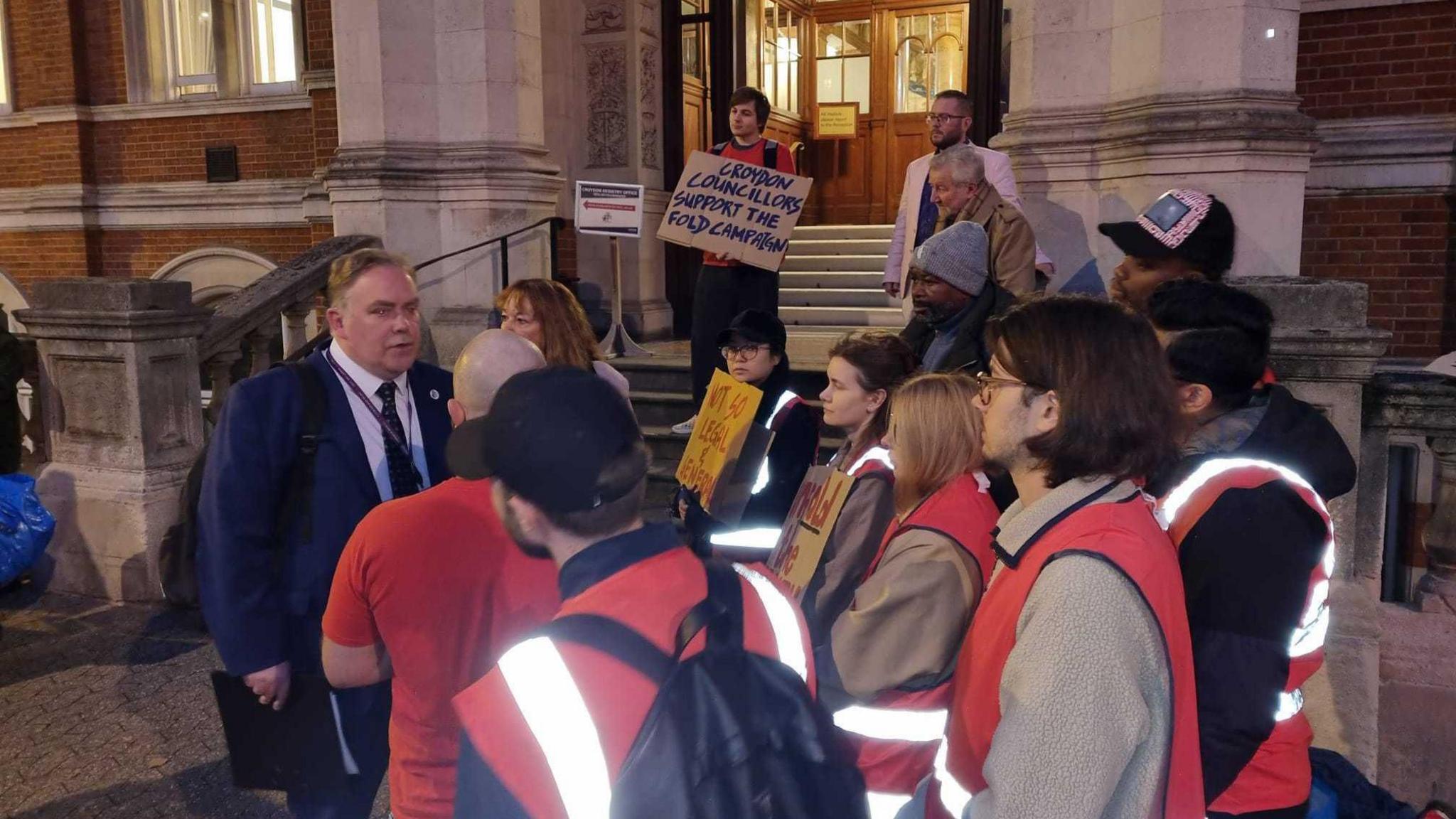 protesters talk to mayor jason perry outside the town hall