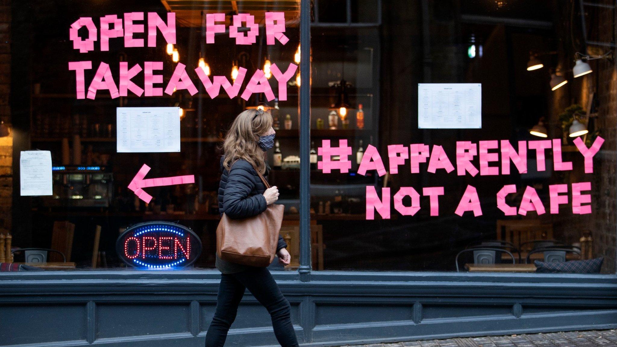 Woman walking past cafe