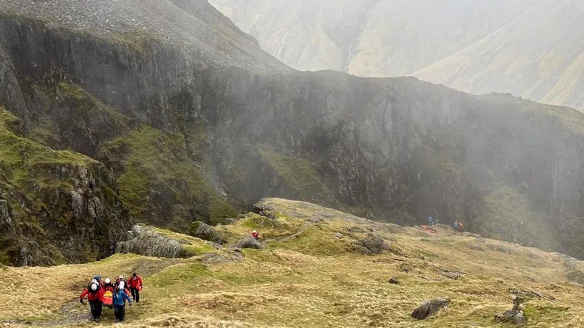 A mountain rescue team carrying a casualty up from Piers Gill