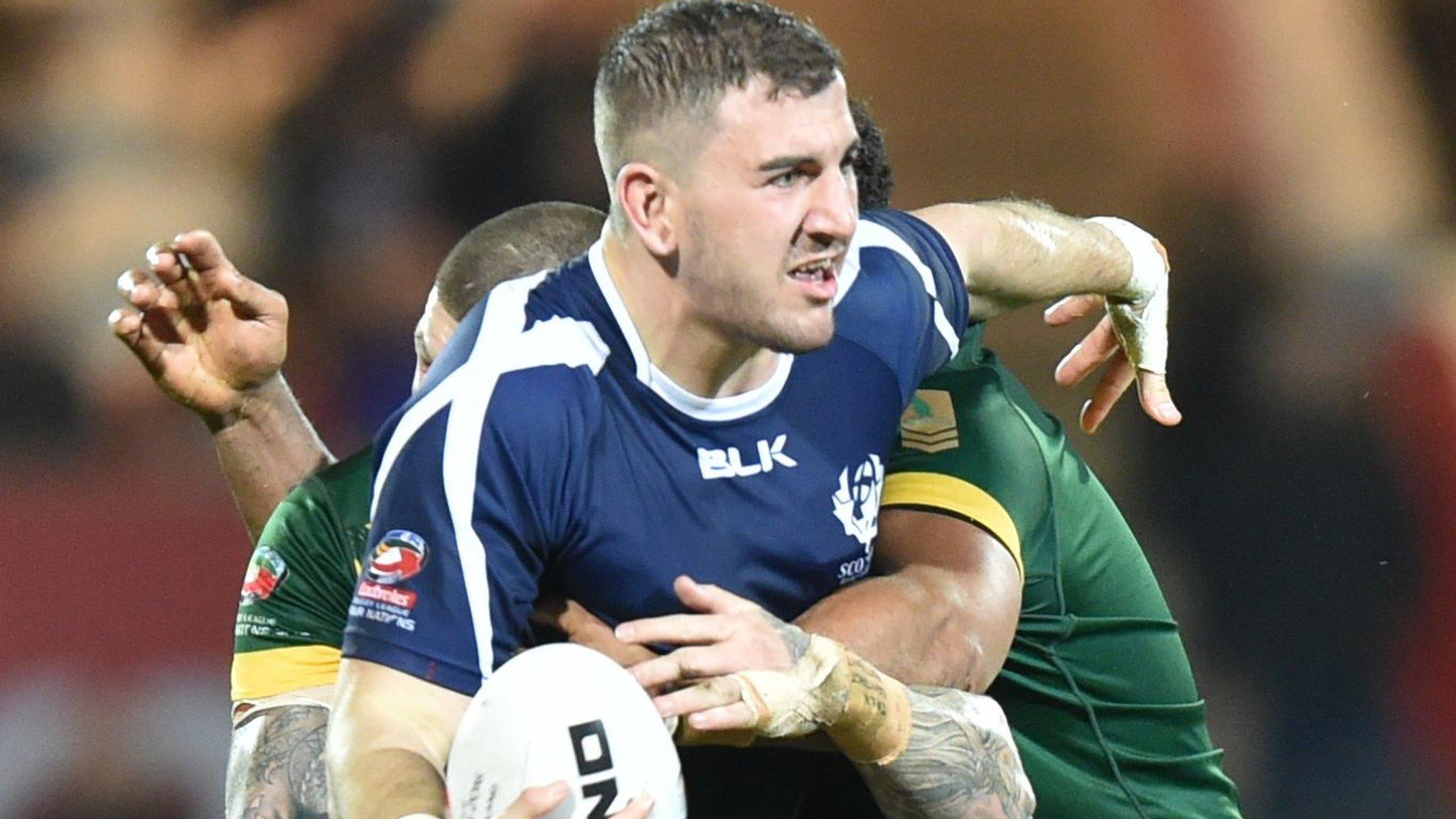 Scotland's Adam Walker is tackled against Australia