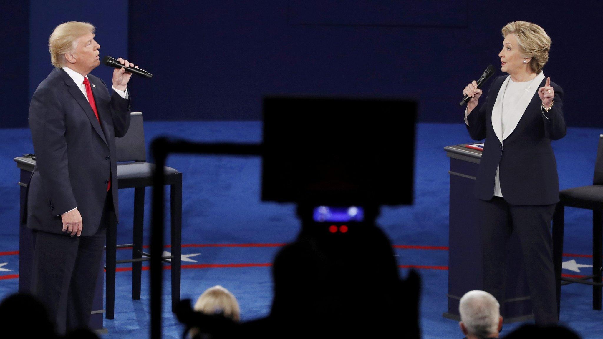 Republican U.S. presidential nominee Donald Trump and Democratic U.S. presidential nominee Hillary Clinton speak during their presidential town hall debate at Washington University in St. Louis, Missouri, U.S., October 9, 2016.