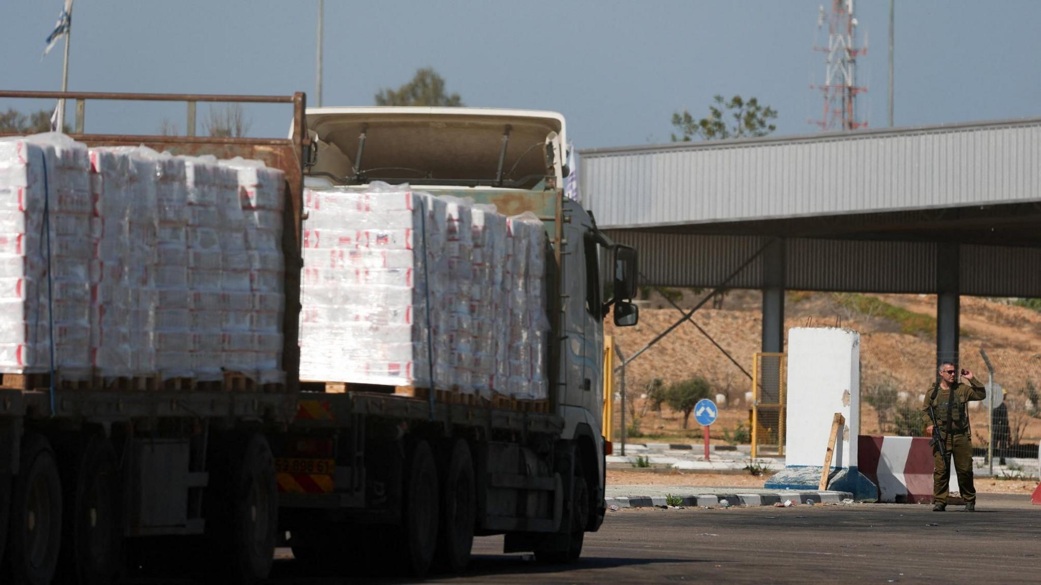 A lorry carrying aid waits at the Israeli side of the Kerem Shalom border crossing with southern Gaza (20 October 2025)