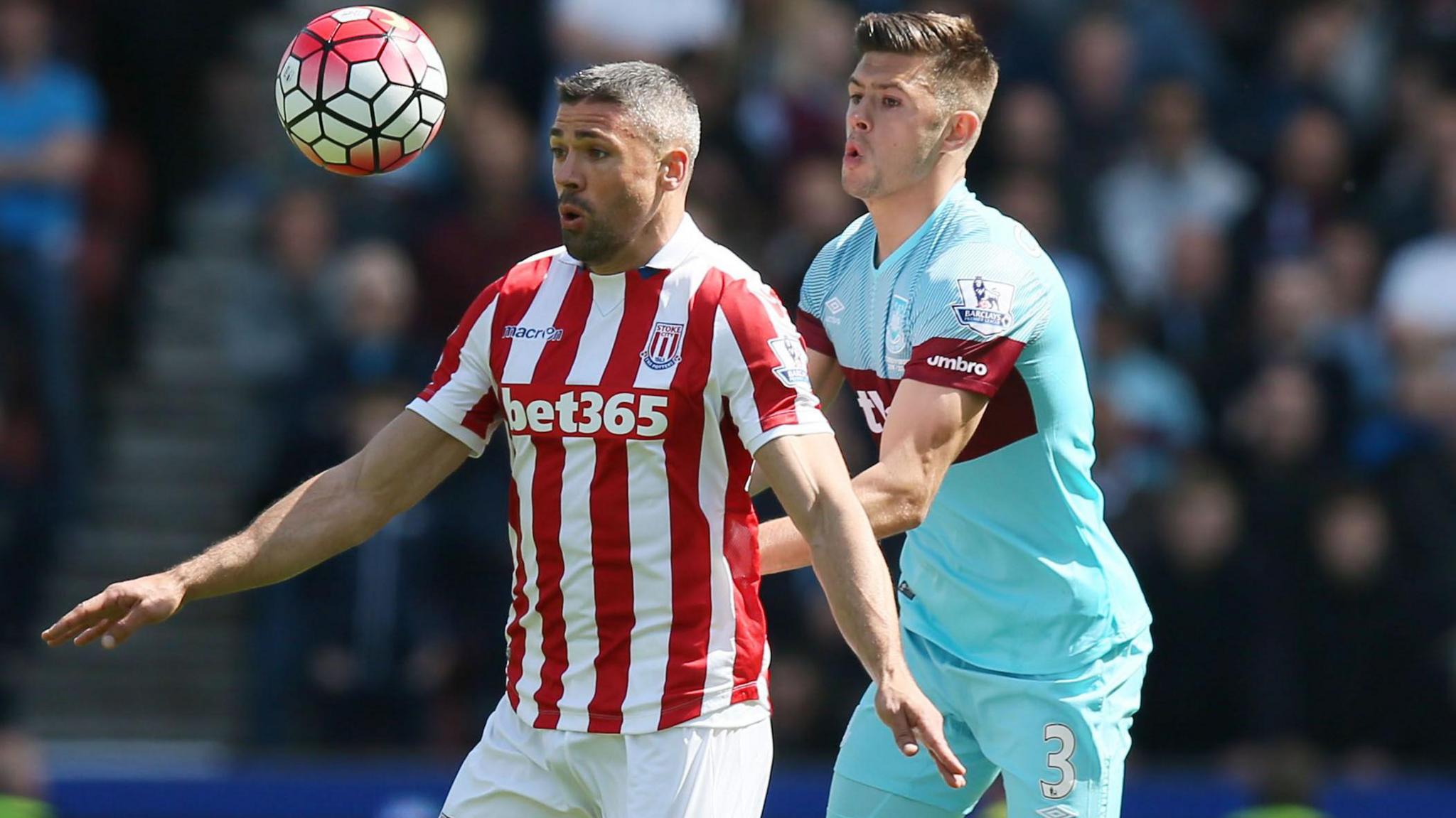 Aaron Cresswell, on the right, challenges Jonathan Walkers, now the Stoke City sporting director, from behind during a Premier League game between Stoke and West Ham