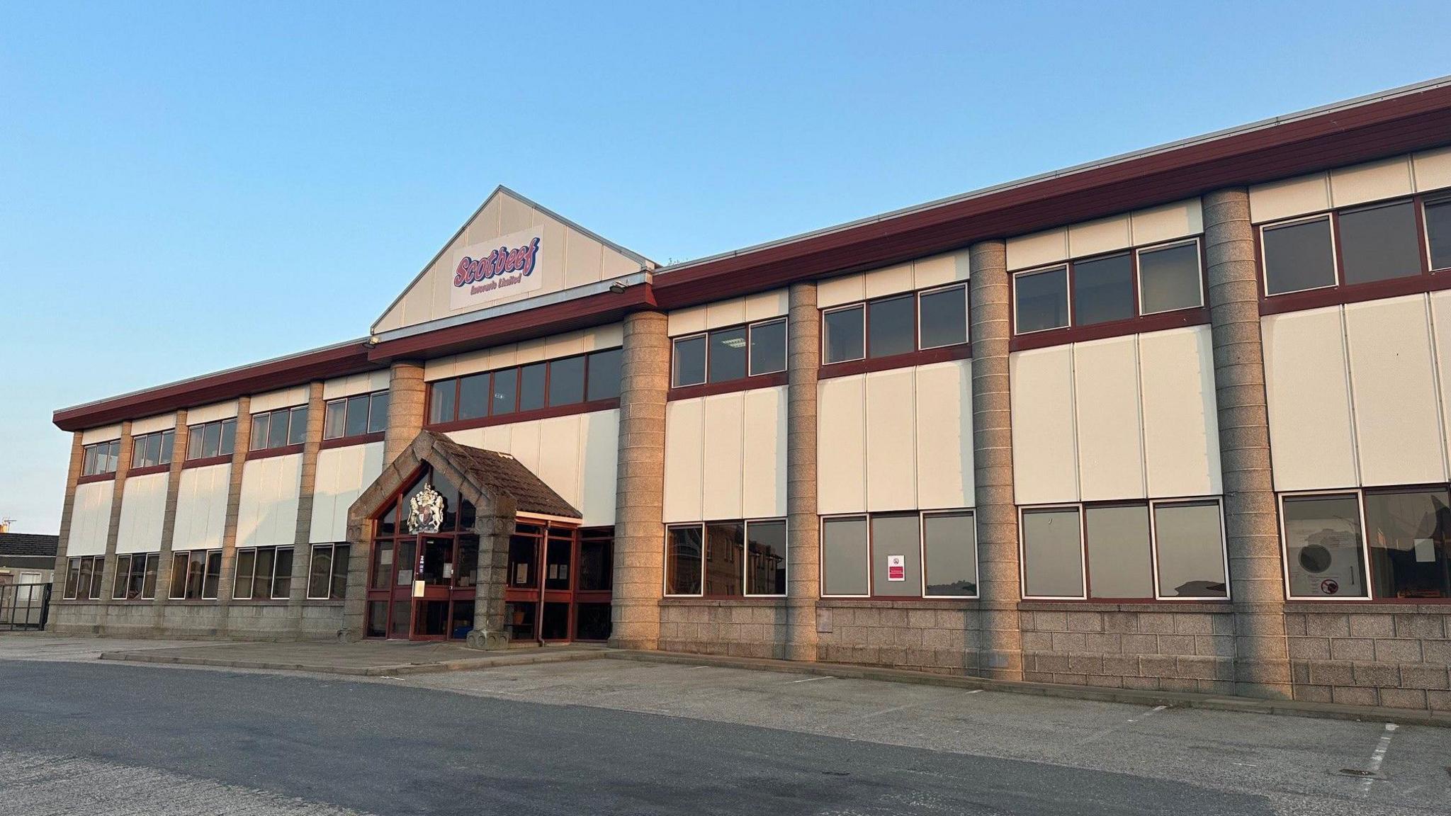 a building with a red and blue logo on the front which reads Scotbeef Inverurie