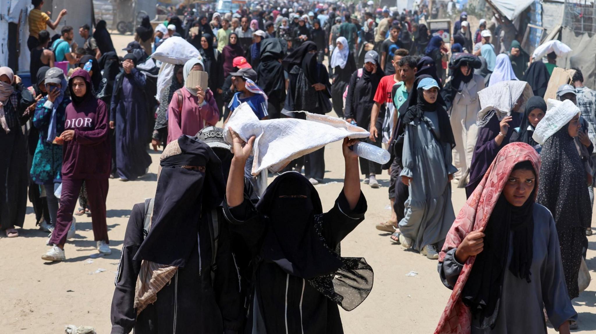 Palestinian women and girls seek aid supplies from a distribution site in southern Gaza run by the US- and Israel-backed Gaza Humanitarian Foundation (GHF), near Rafah, in the southern Gaza Strip (24 July 2025)