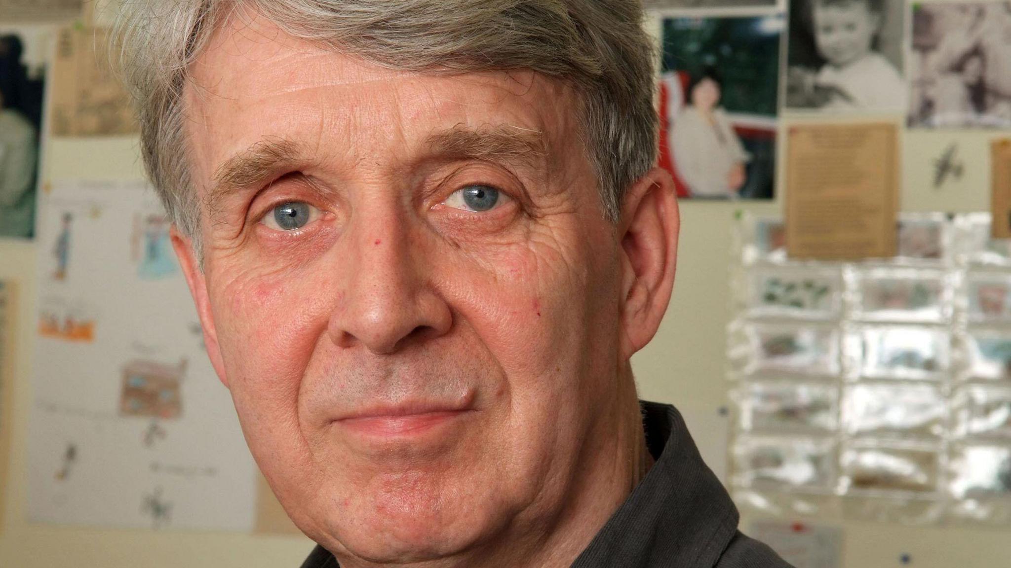 Portrait of Allan Ahlberg staring directly at the camera. He has blue eyes and grey hair.