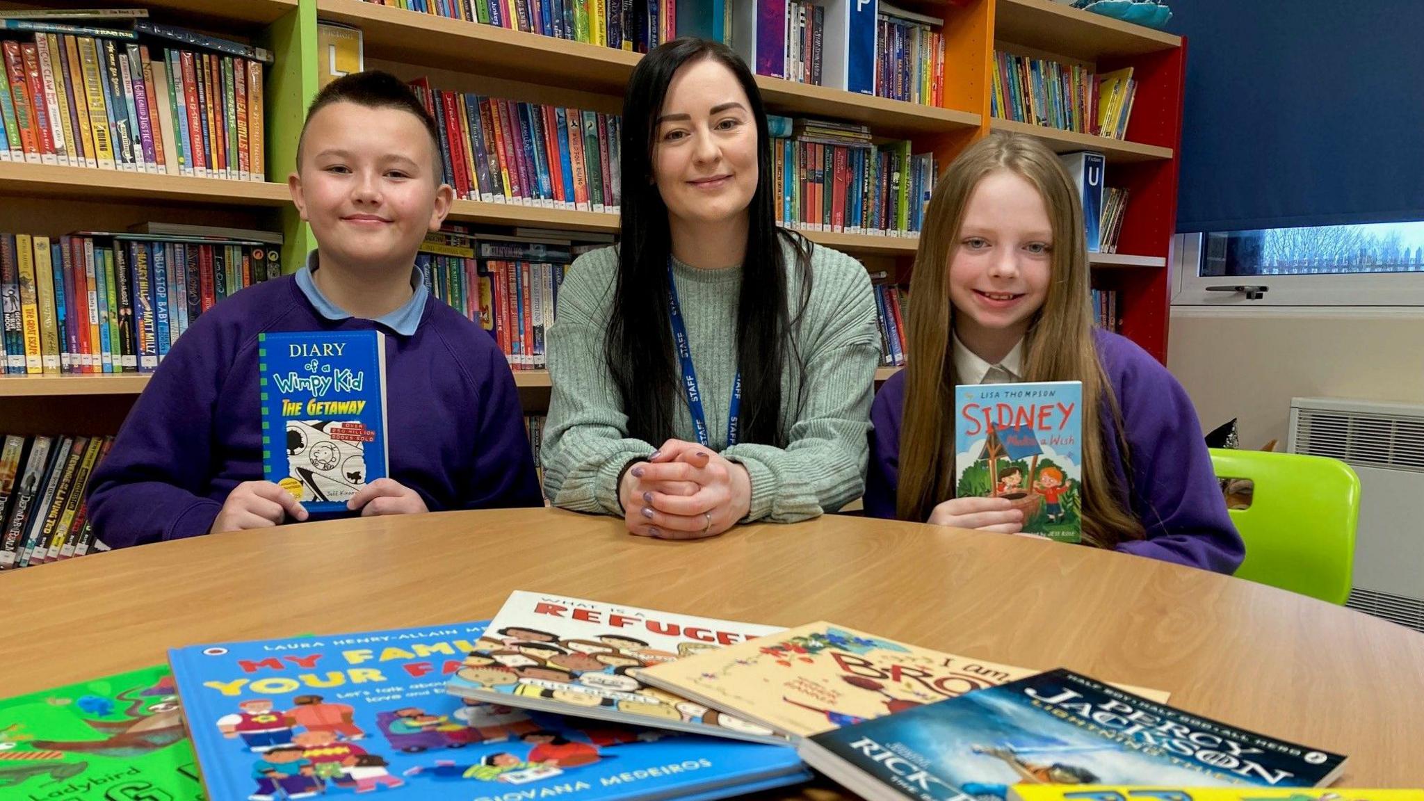 A teacher and her pupils in a school library