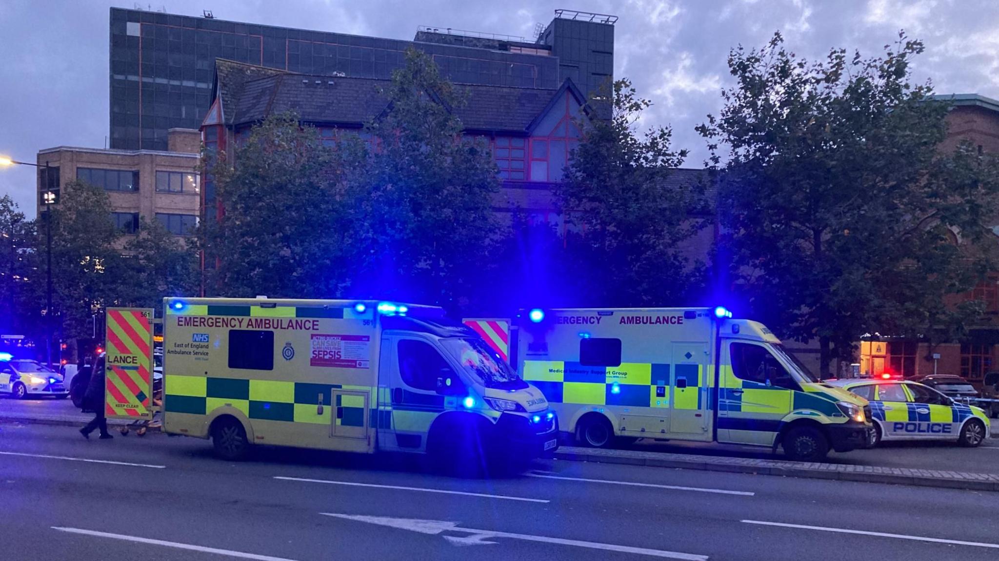 Two ambulances, one on each carriageway of Civic Drive, Ipswich, with police cars nearby.