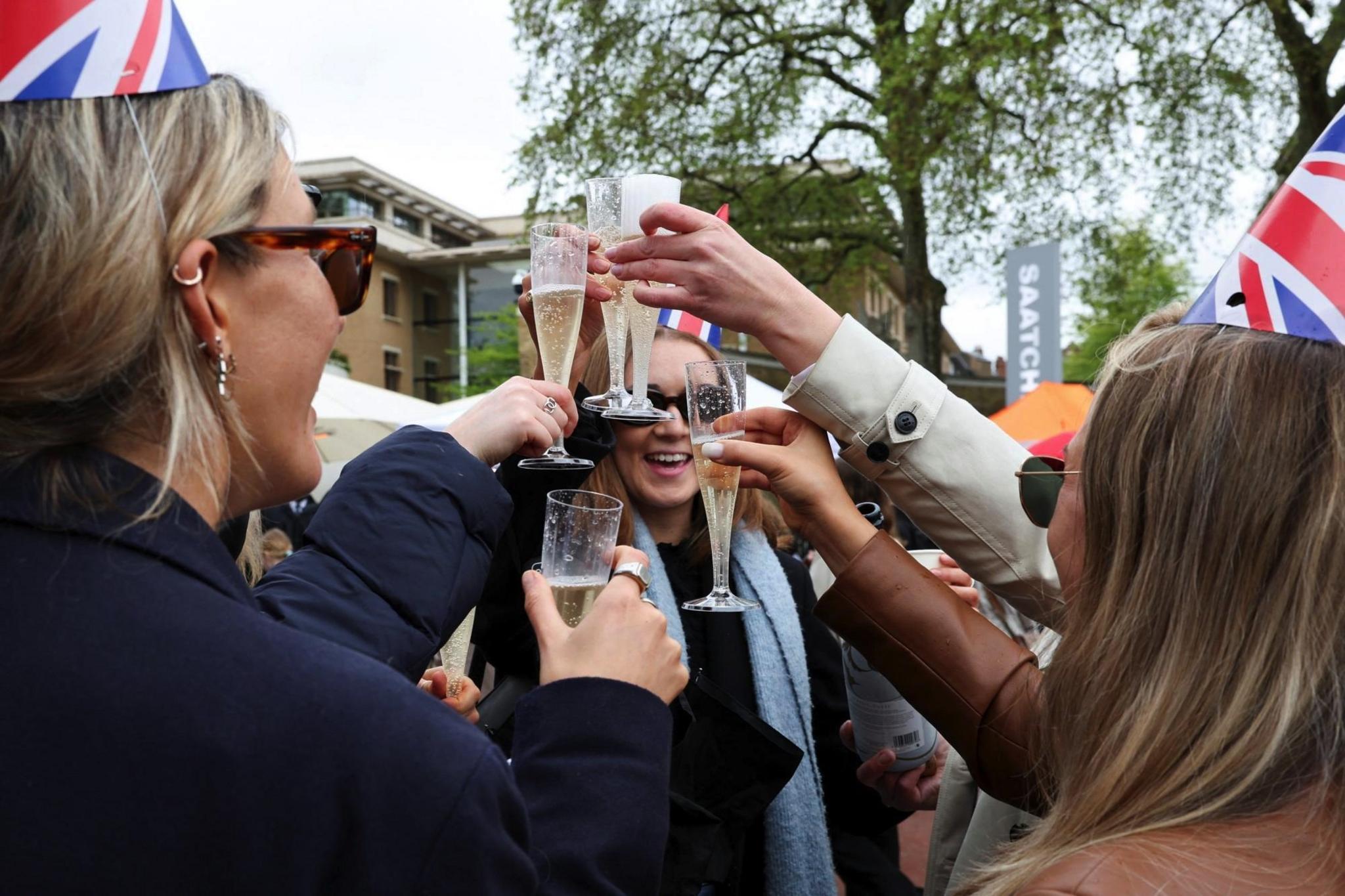 People take part in celebrations following Britain's King Charles and Queen Camilla's coronation