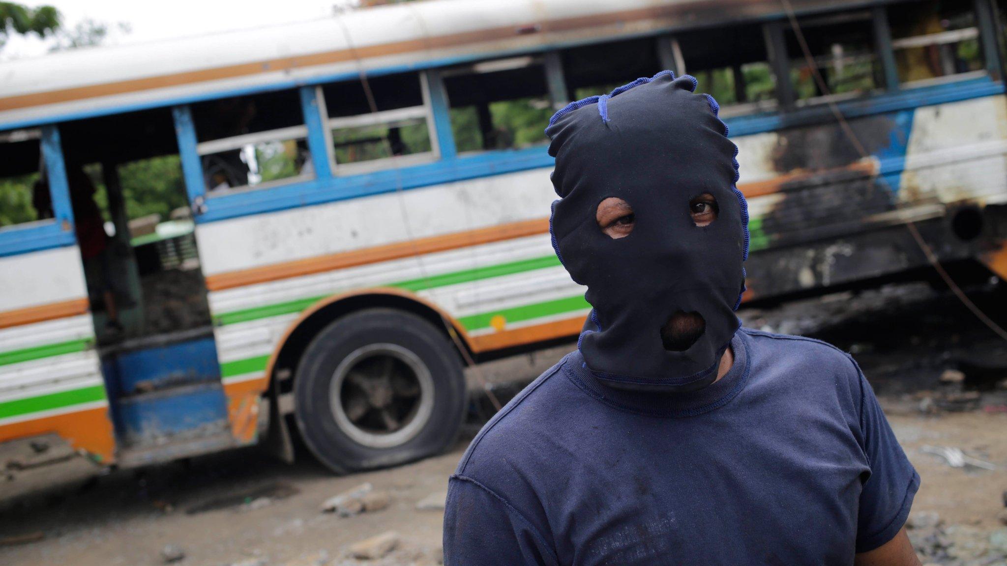 Demonstrators use a burned bus as a barricade during a protest against President Daniel Ortega in Tipitapa, Nicaragua June 14, 2018