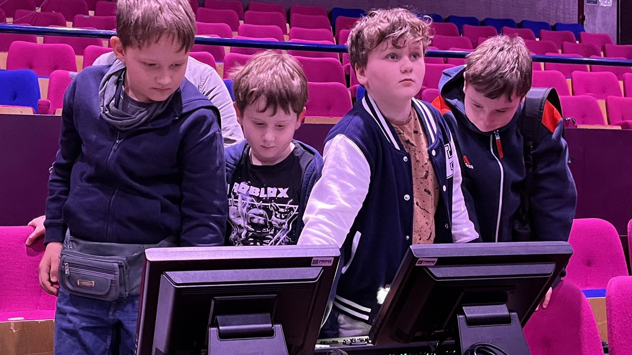 Four children controlling the light on the Wyvern Theatre stage