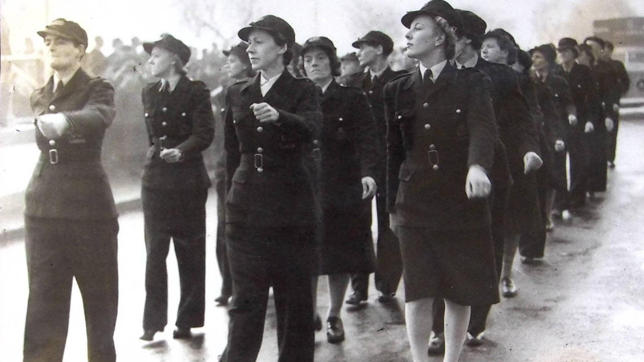 Women parading in London as part of the London Auxiliary Ambulance Service, wearing dark uniforms and hats