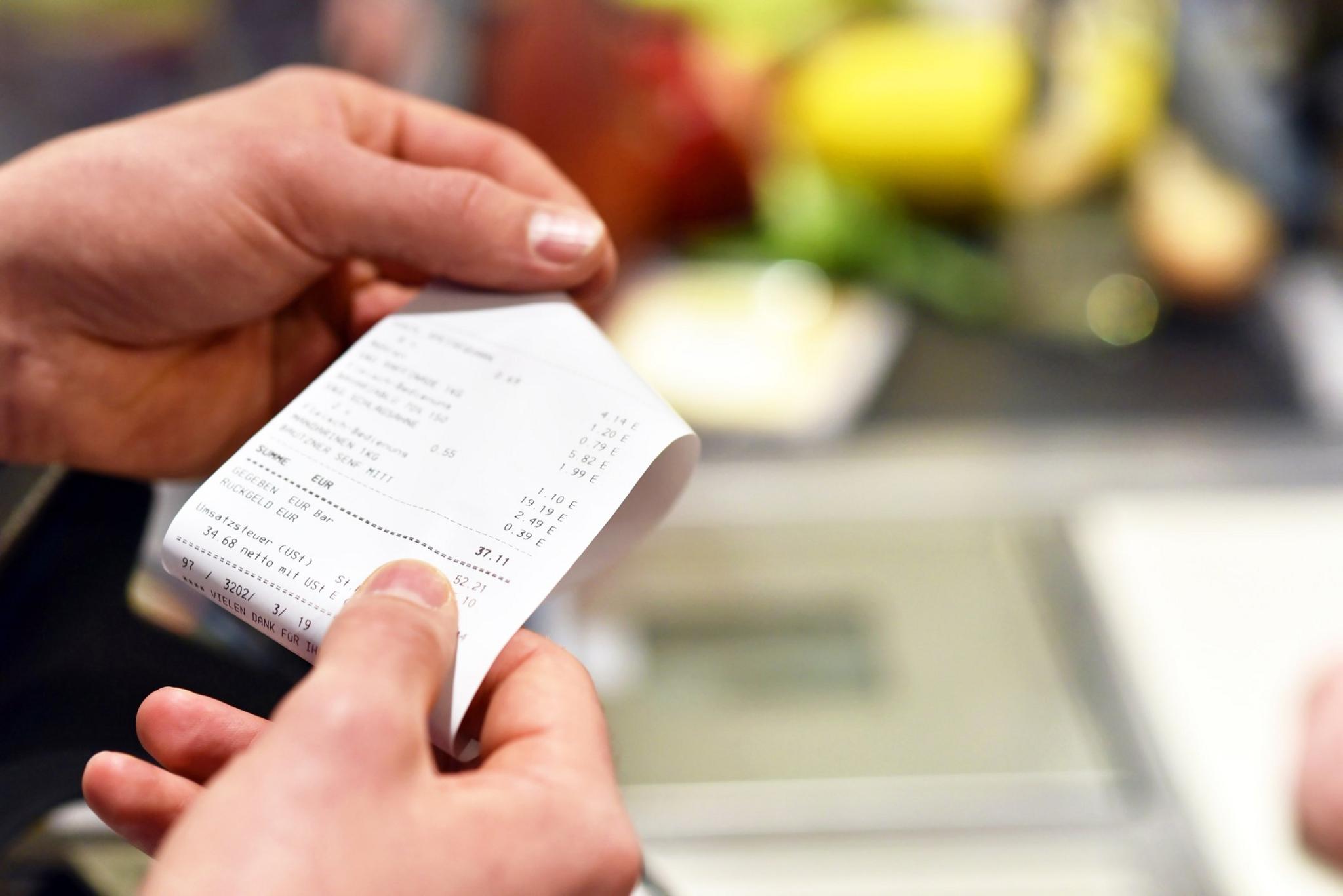 Photo of a woman looking at a receipt