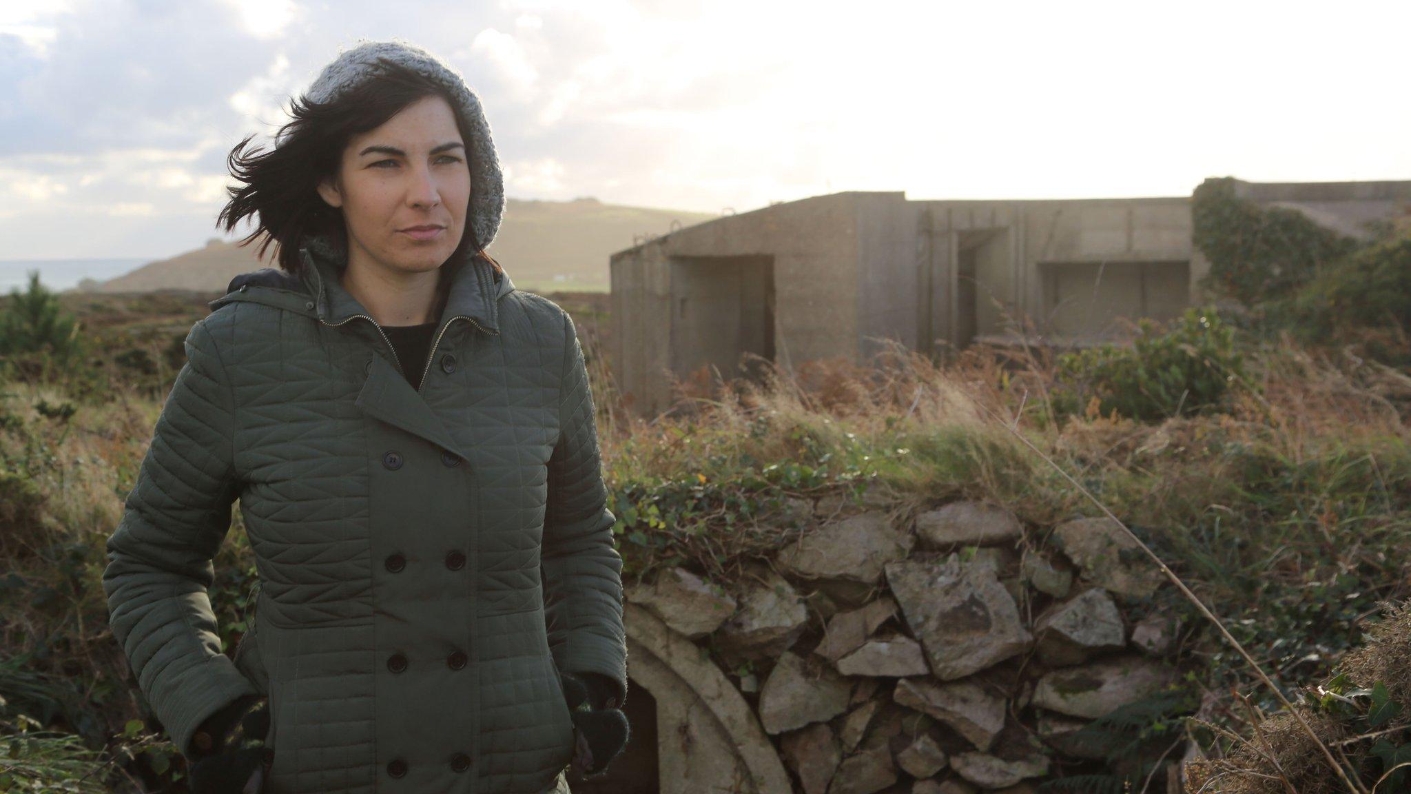 Woman standing next to World War Two fortifications