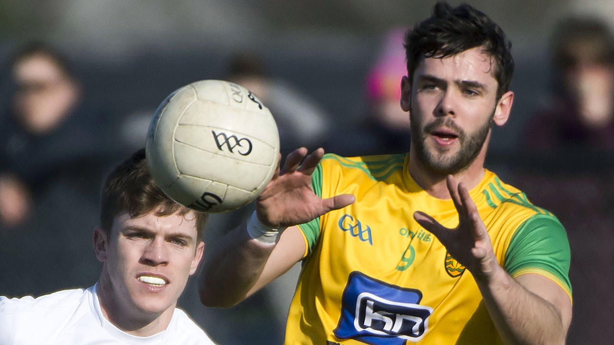 Donegal's Odhran MacNiallais beats Kevin Feely to win possession in Ballyshannon