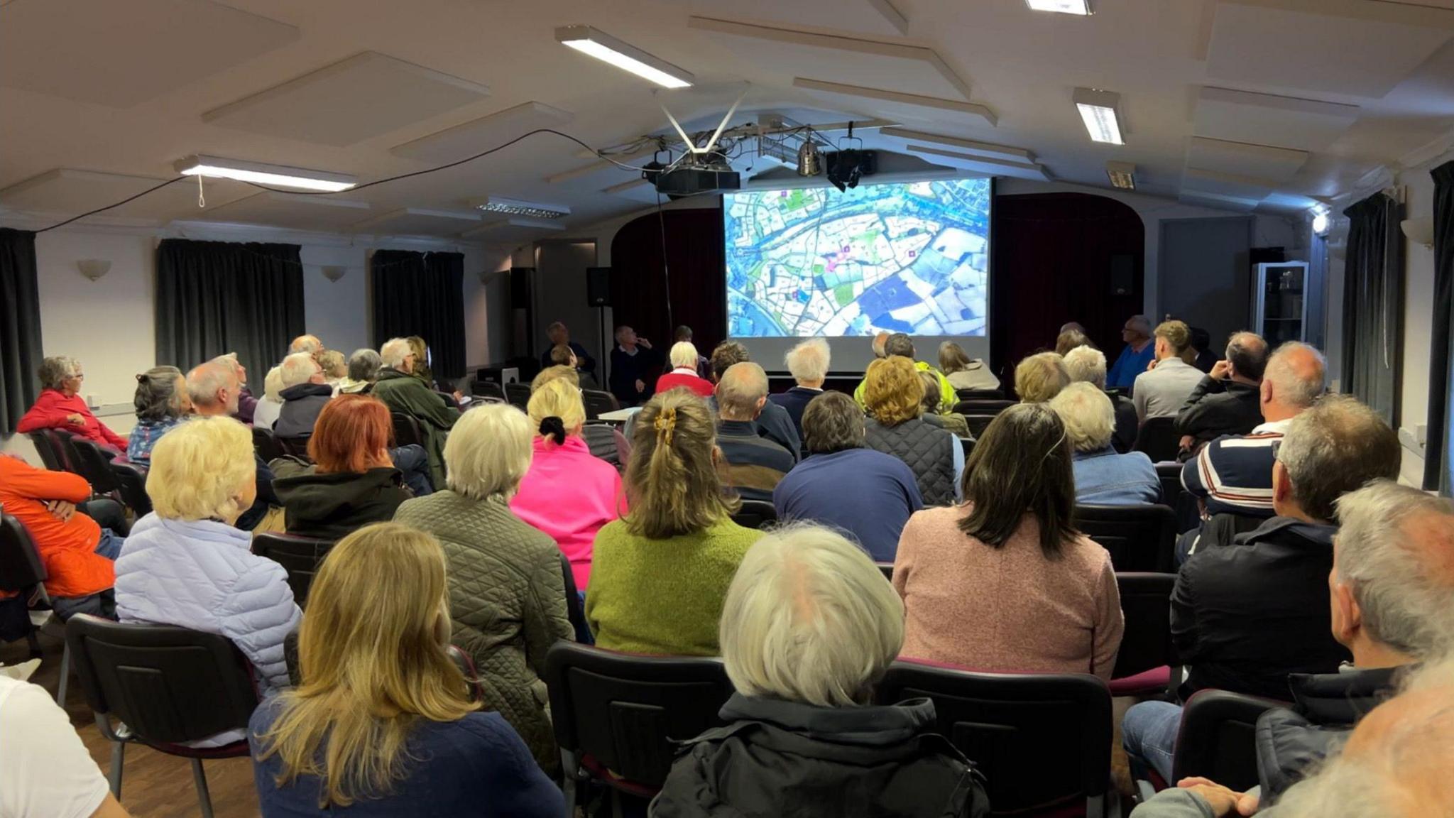 Residents gathering for a meeting about a proposed housing development in Hatton