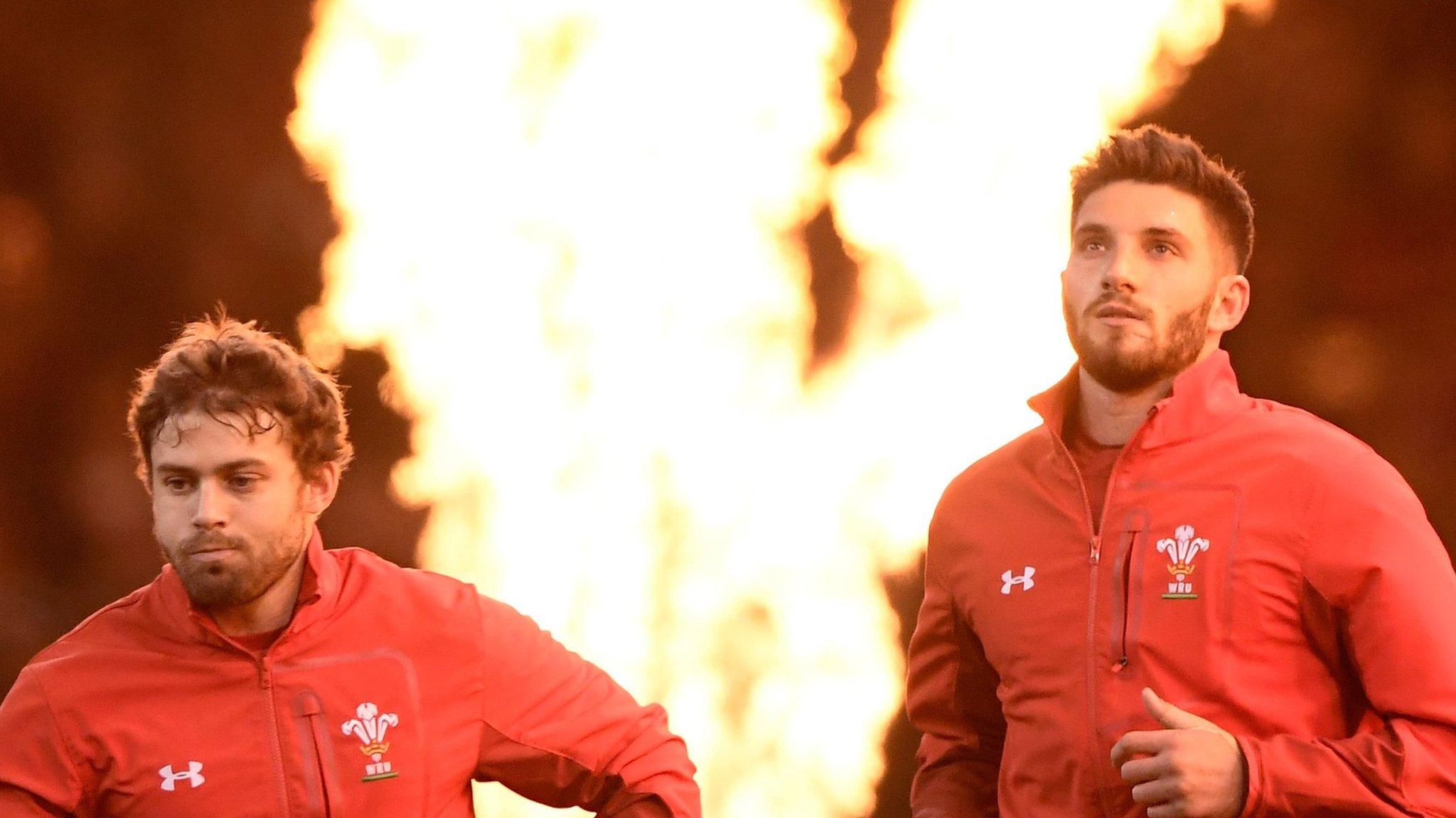 Leigh Halfpenny and Owen Williams run onto the pitch as a flamethrower goes off in the background