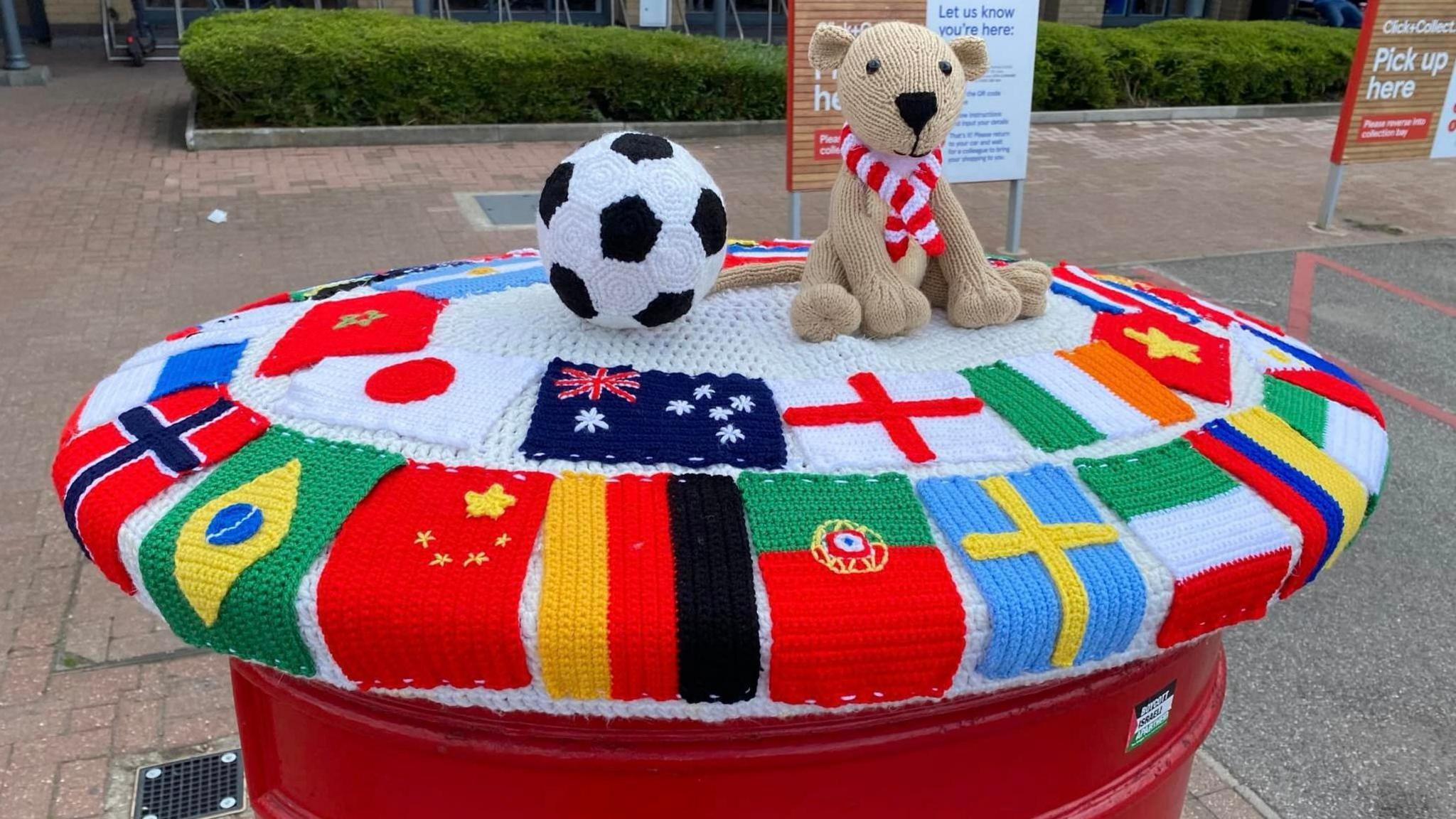 Postbox topper with flags on