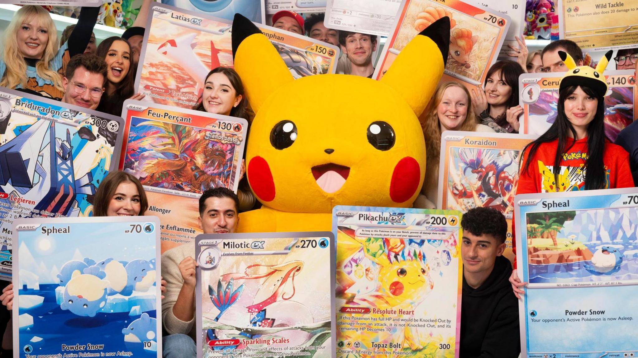 Pokemon fans pose with oversized cards and Pikachu to celebrate the World Record 