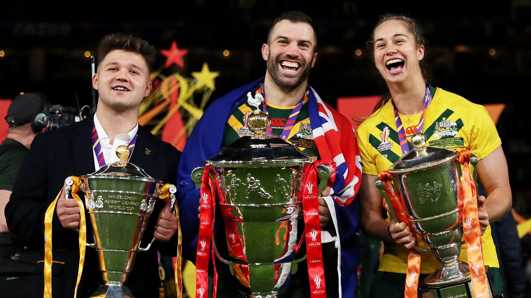 Tom Halliwell of England Wheelchair, James Tedesco of Australia and Kezie Apps of Australia pose for a photograph with their trophies after the Rugby League World Cup Final match between Australia and Samoa at Old Trafford on November 19, 2022