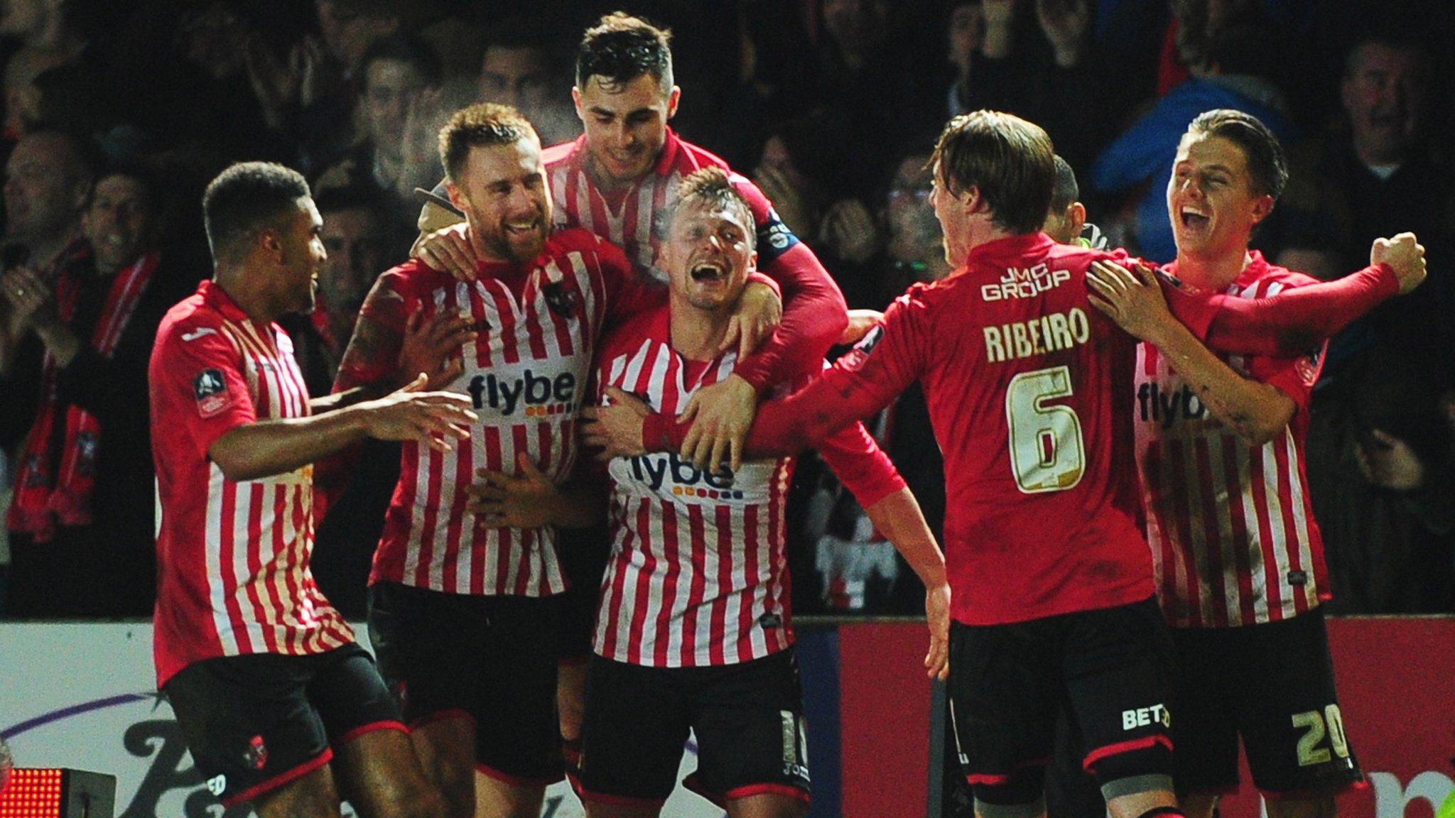 Exeter City players celebrate against Liverpool
