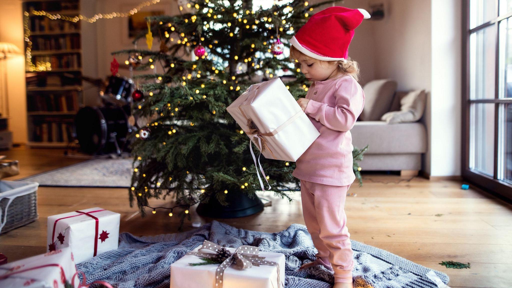 Child opens Christmas presents