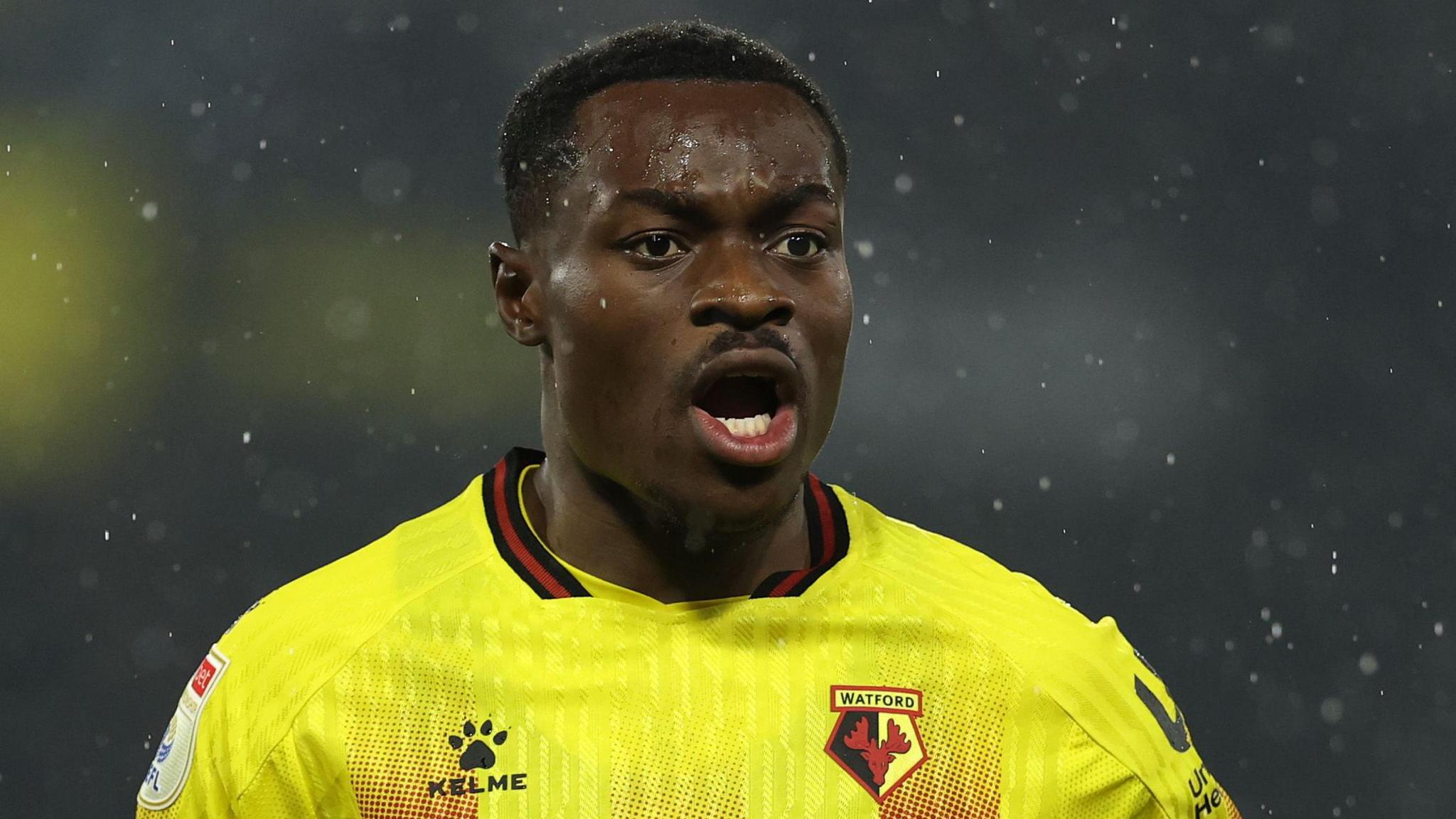 Marc Bola in a yellow Watford FC jersey during a match