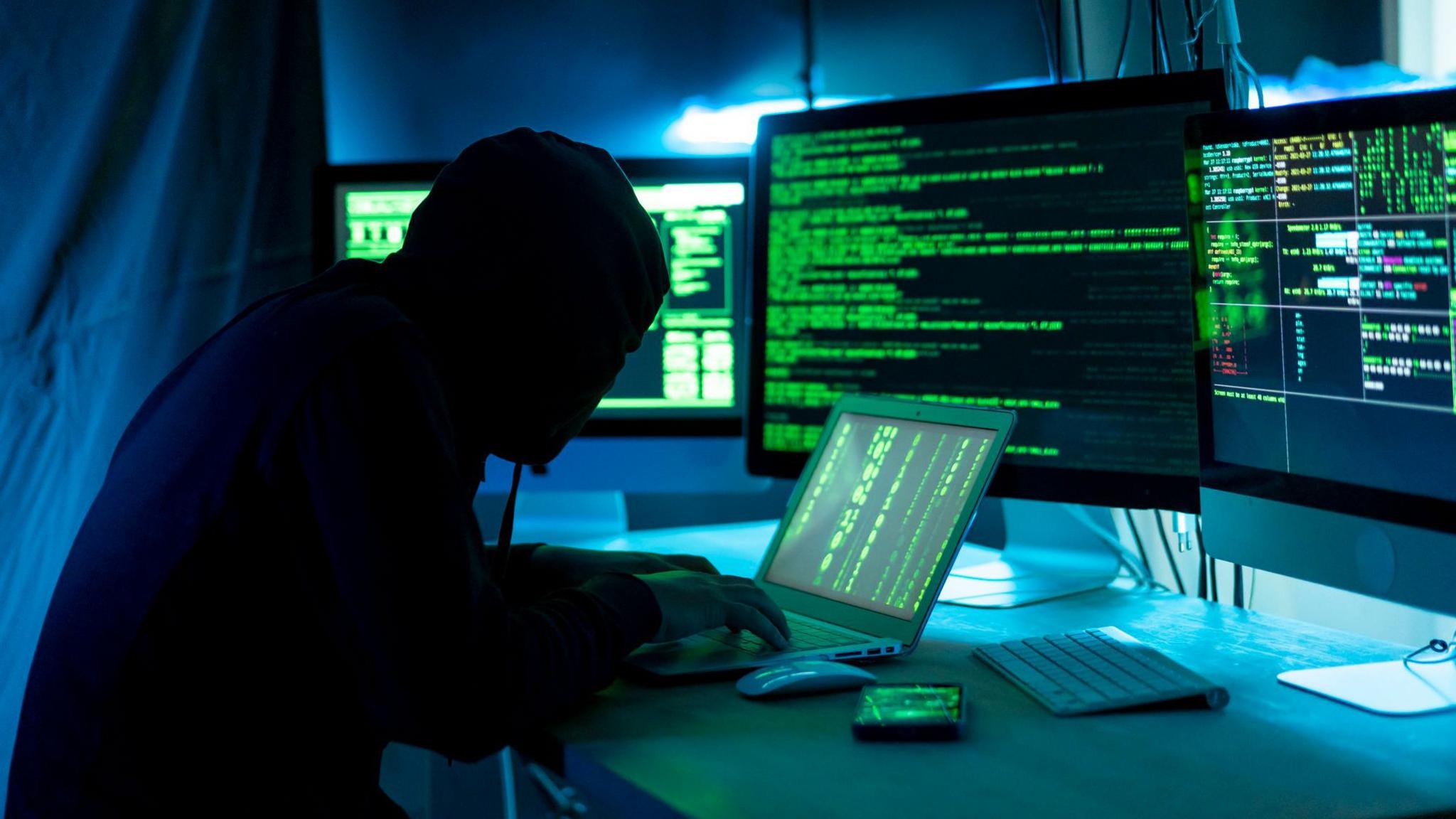 A mock-up of a computer hacker at work