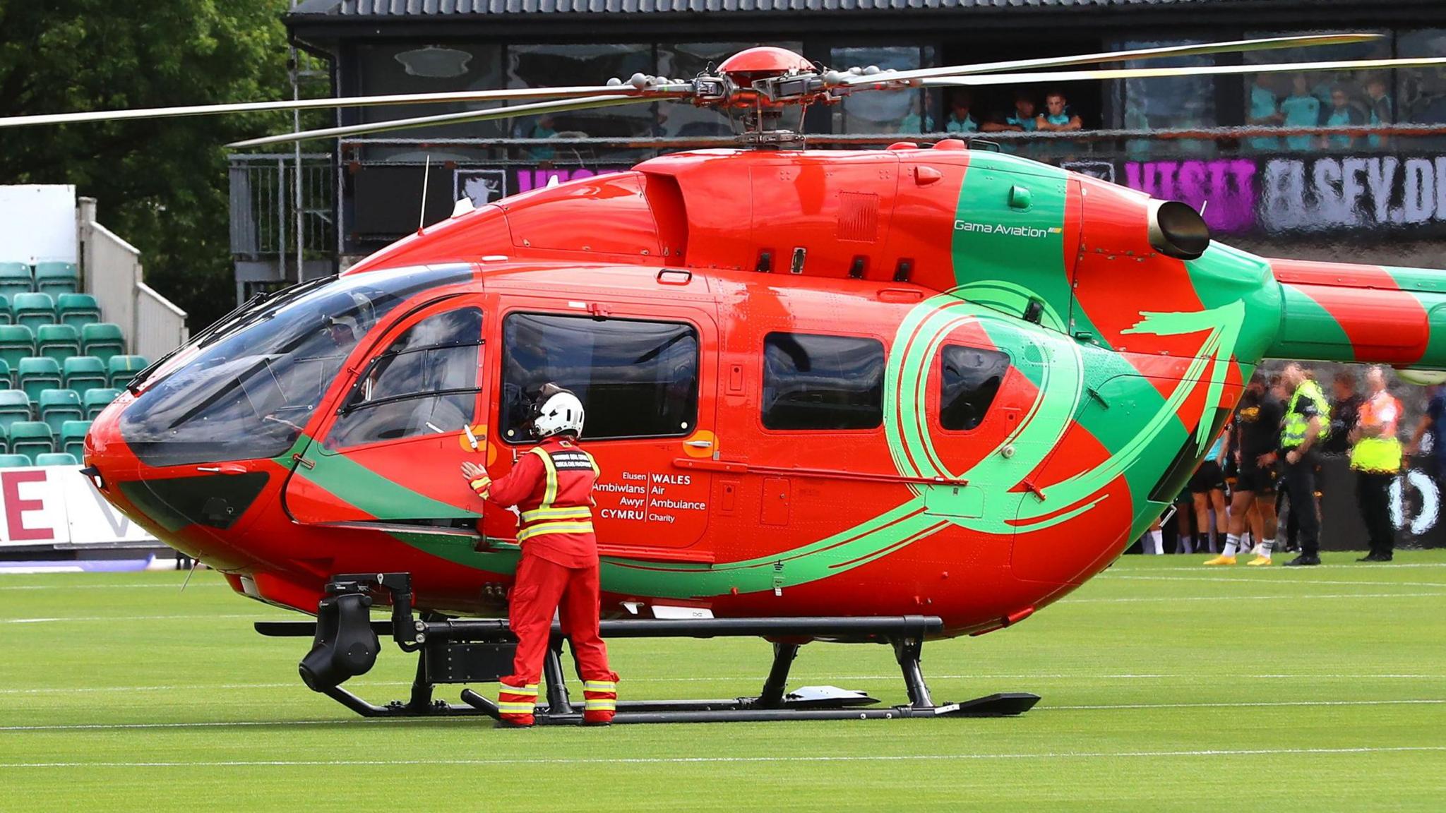 An air ambulance helicopter landing on the pitch at Newport County.