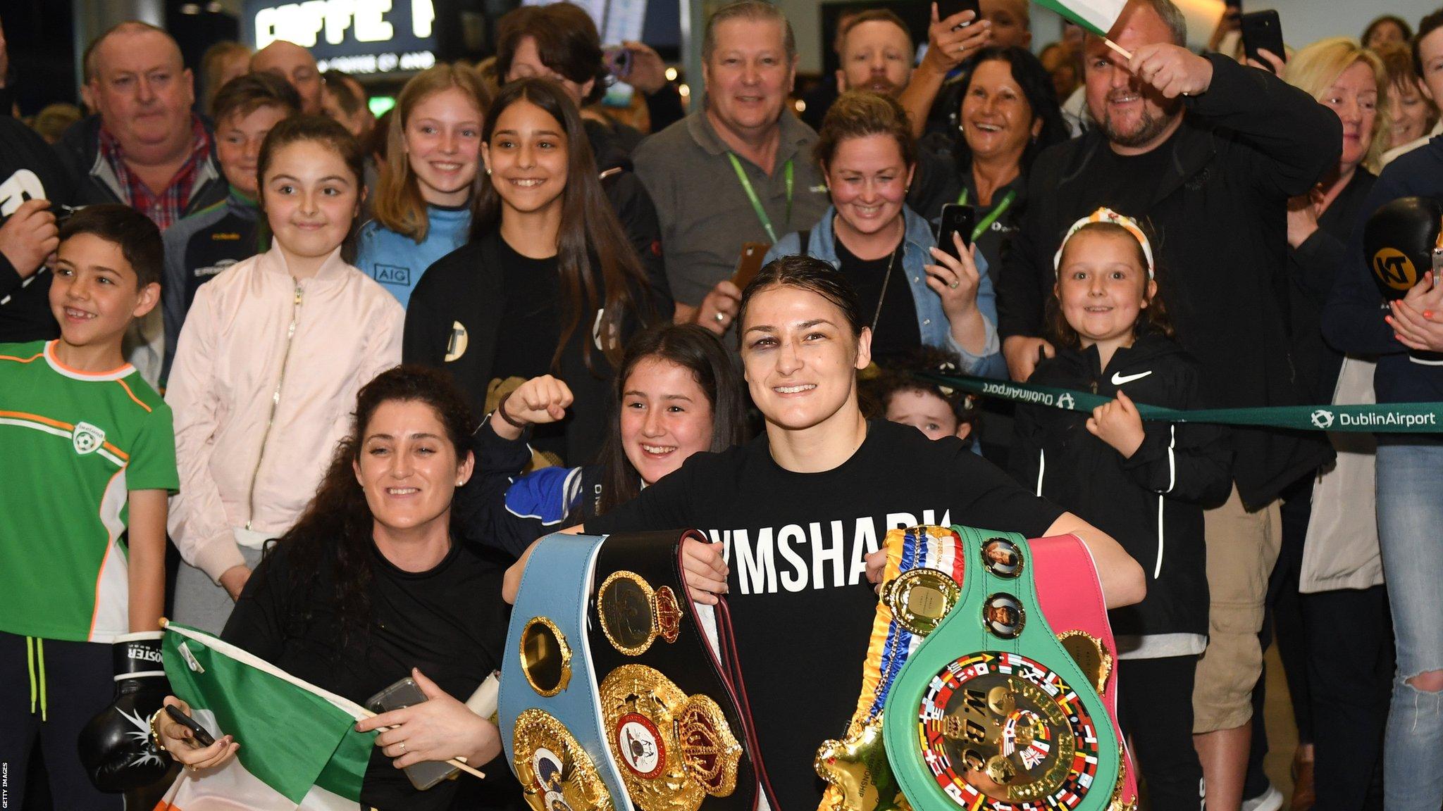 Dublin, Ireland, 4 June: Katie Taylor arrives back to Dublin Airport following her Undisputed Female World Lightweight Championship bout victory against Delfine Persoon at Madison Square Garden in New York, USA, on Saturday. Pictured is Undisputed World Lightweight Champion Katie Taylor is welcomed by fans at Dublin Airport in Dublin. (Photo By Harry Murphy/Getty Images)
