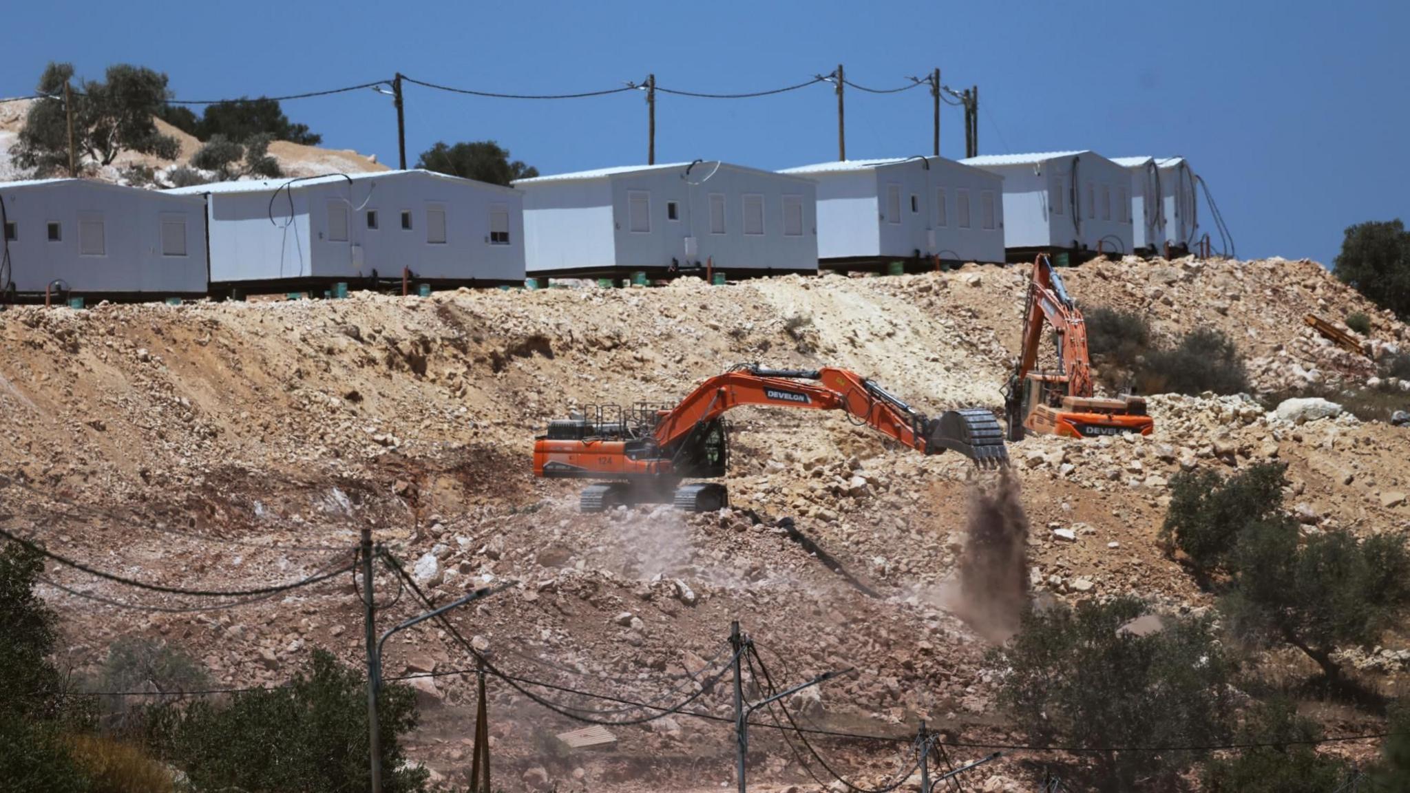 Israeli excavators prepare land for the construction of the new settlement of Mevo Dotan, near the Palestinian city of Jenin,  in the north of the occupied West Bank (13 July 2026)
