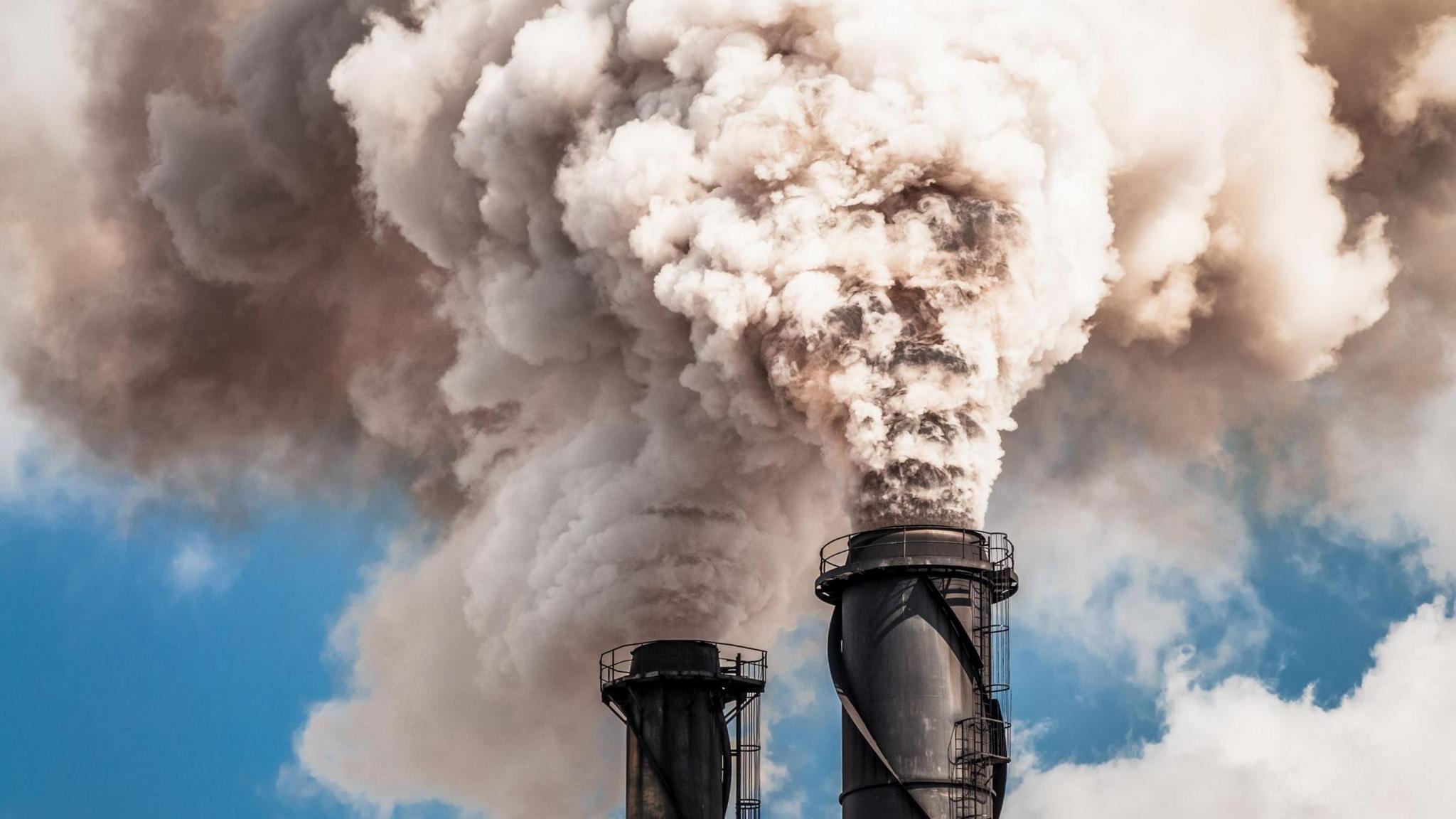 Smoke from fossil fuels blowing into sky