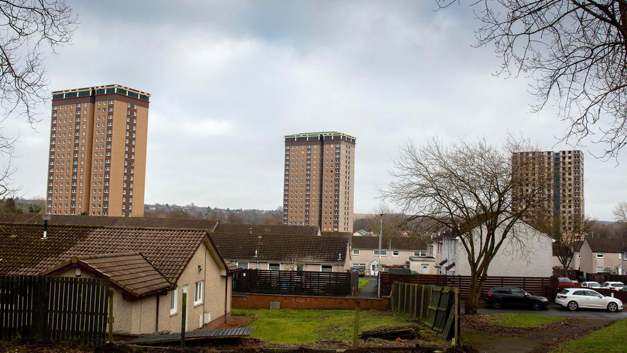 A general view of the Allan, Coursington and Draffen Towers in Motherwell. The three towers are made of light brick and are in the background of the picture.