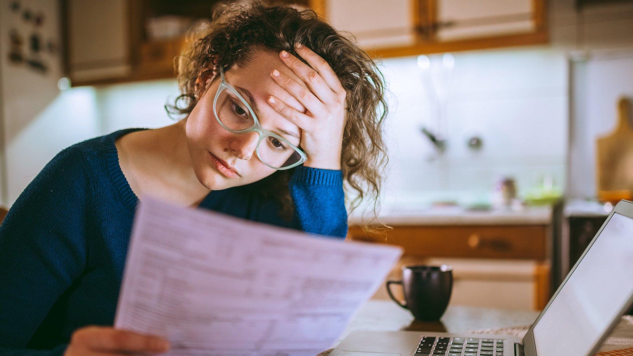 Woman worrying over a bill