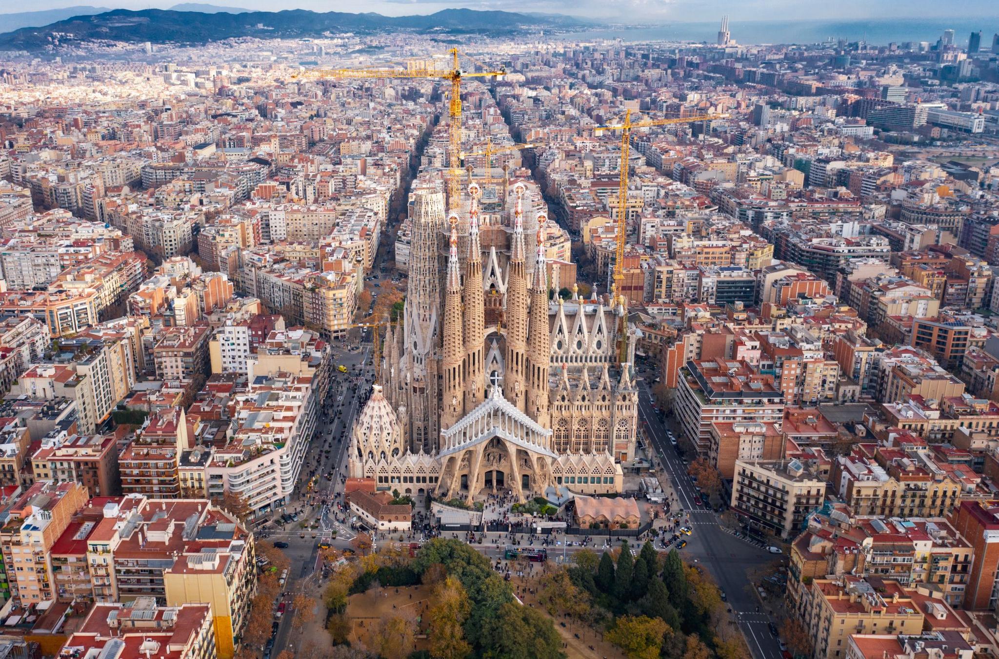 Aerial view of Barcelona showing la Sagrada Familia with construction cranes seen in the background