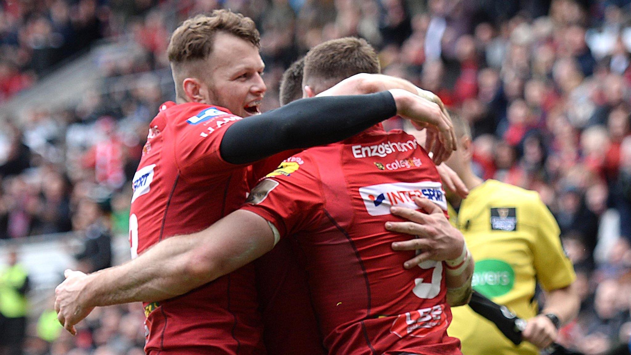 Steff Hughes (L) joins in the Scarlets' celebrations for Gareth Davies' try