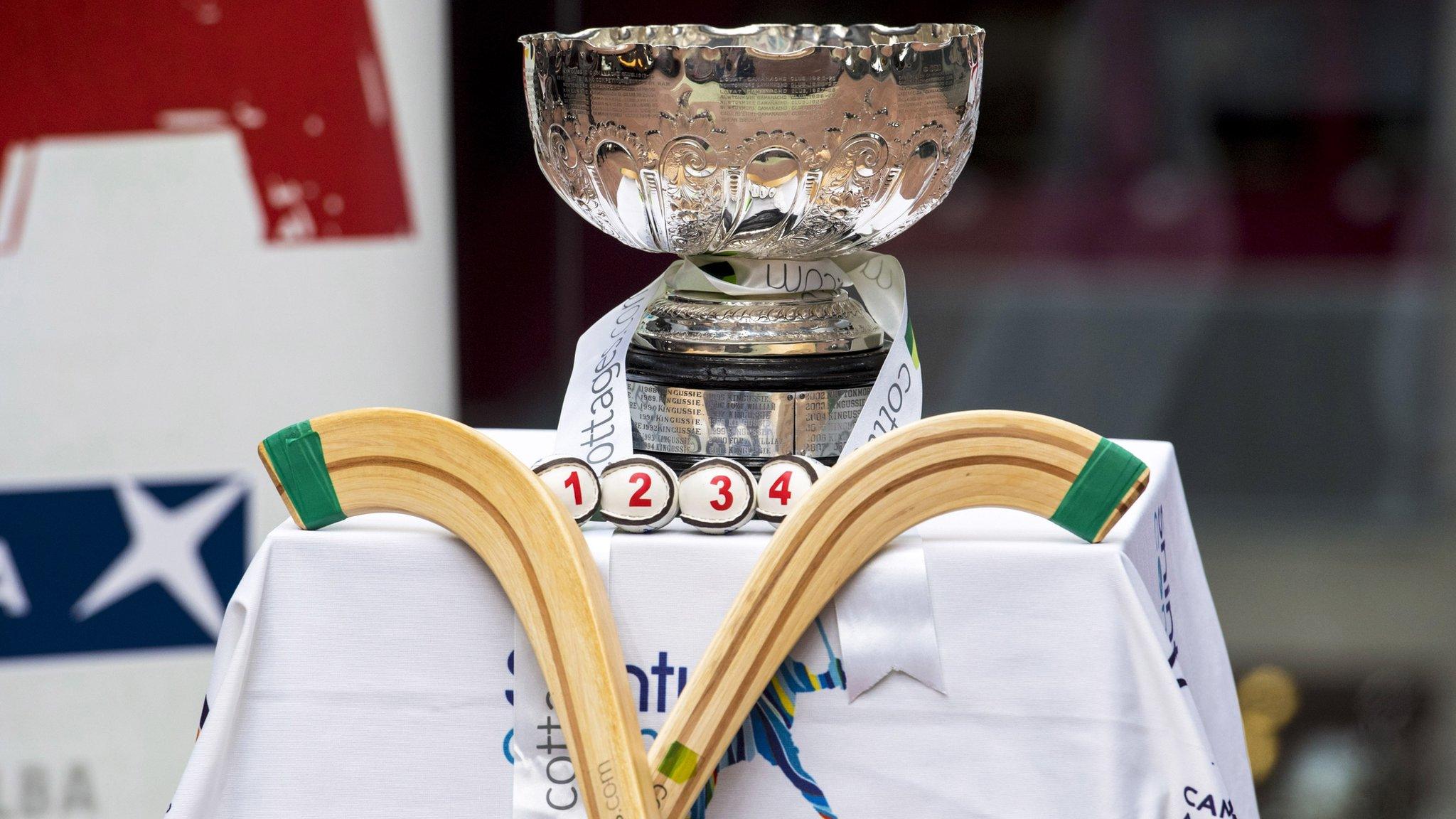 Shinty sticks and a trophy