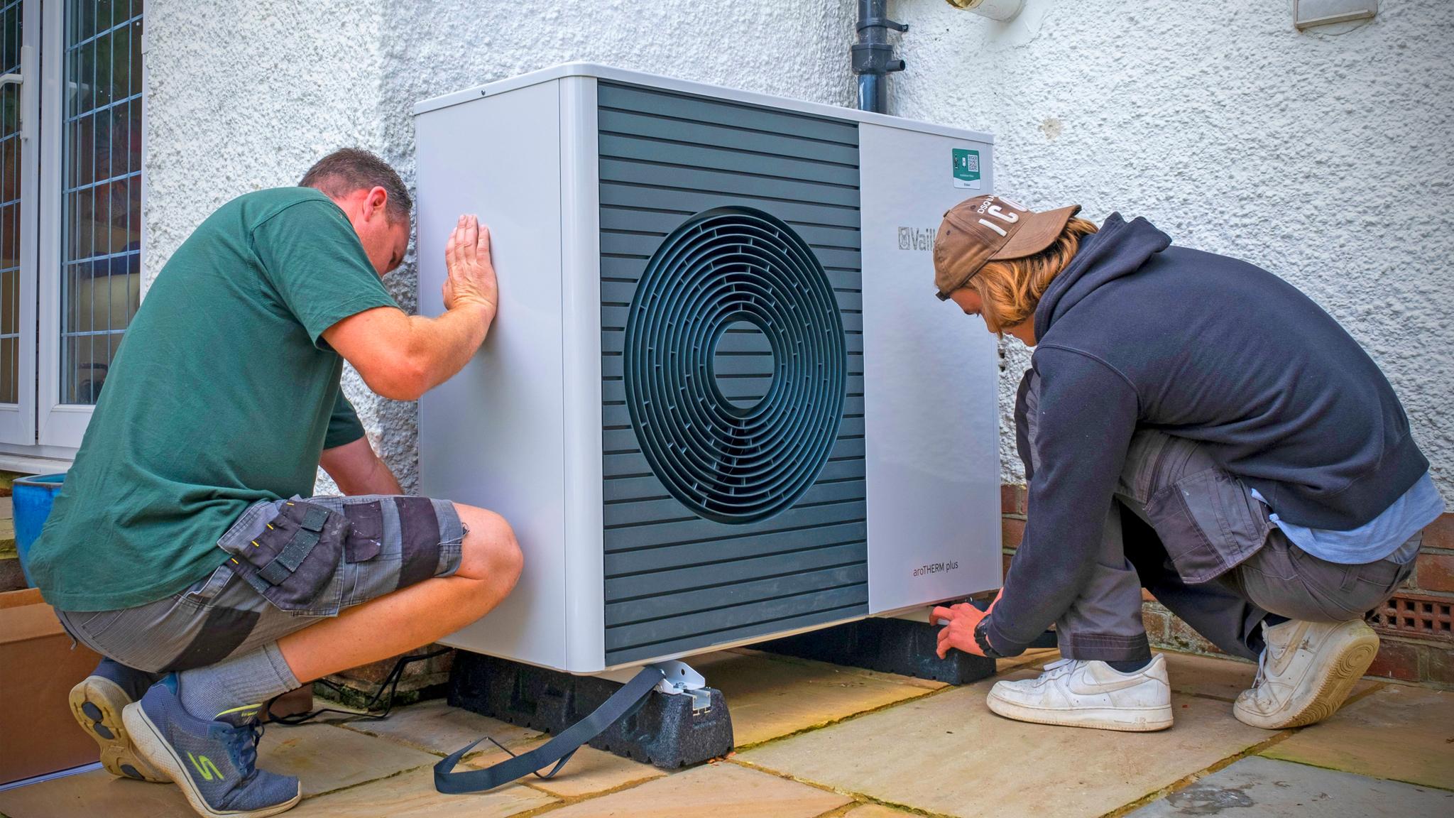 people-installing-heat-pump