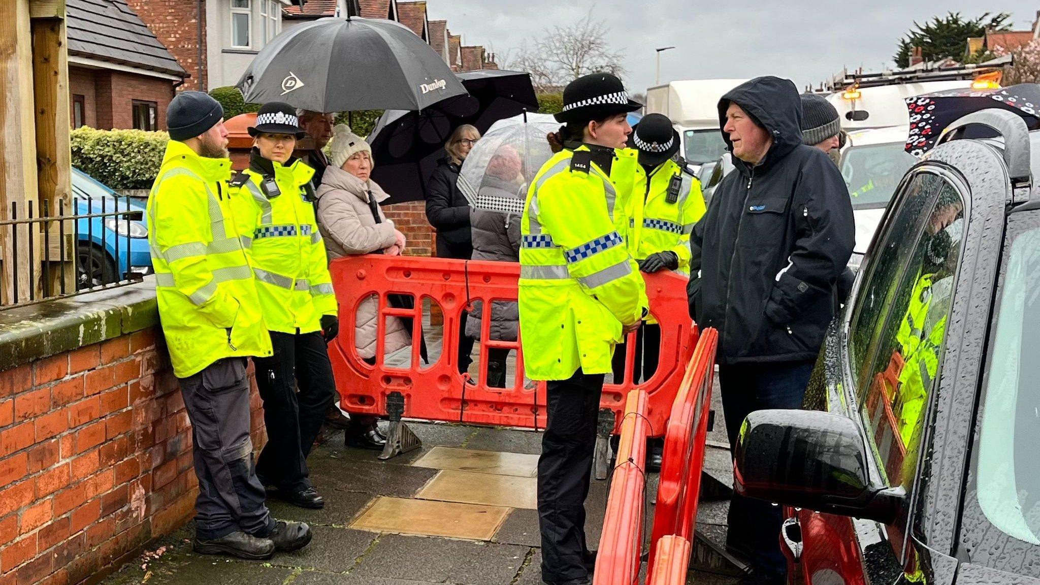 Police in attendance as residents blockade a road in Southport