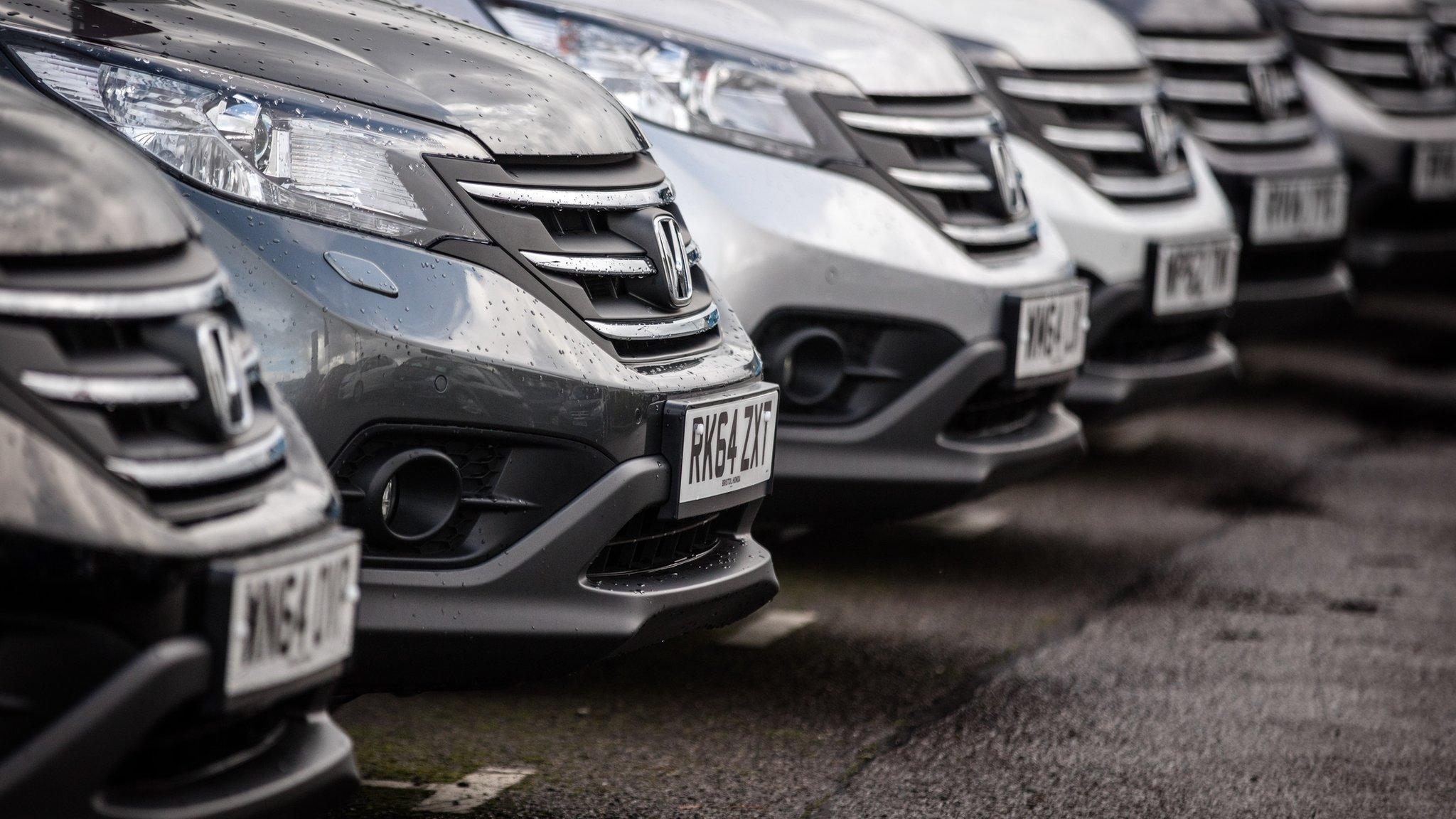 cars lined up on forecourt