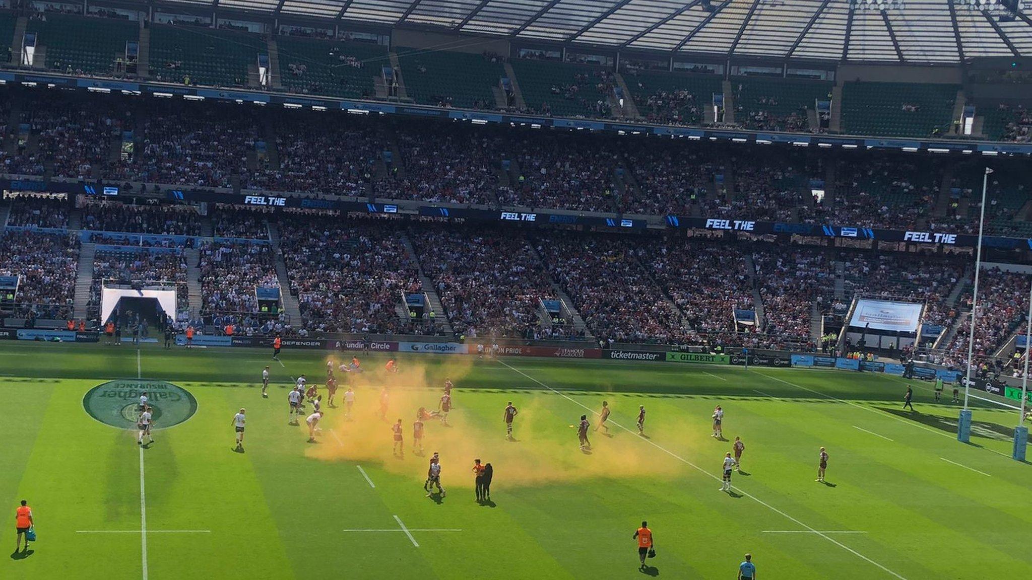 Protestors let off orange smoke bombs