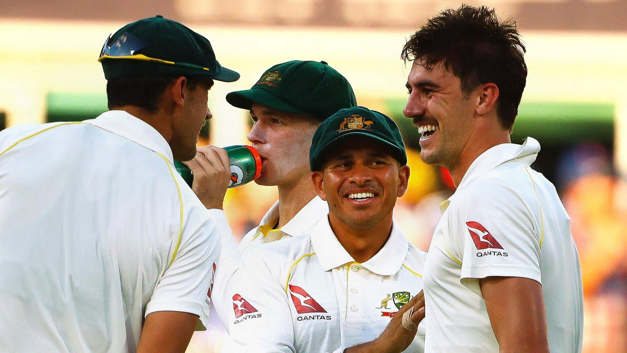 Australia celebrate a wicket by Pat Cummins (right)